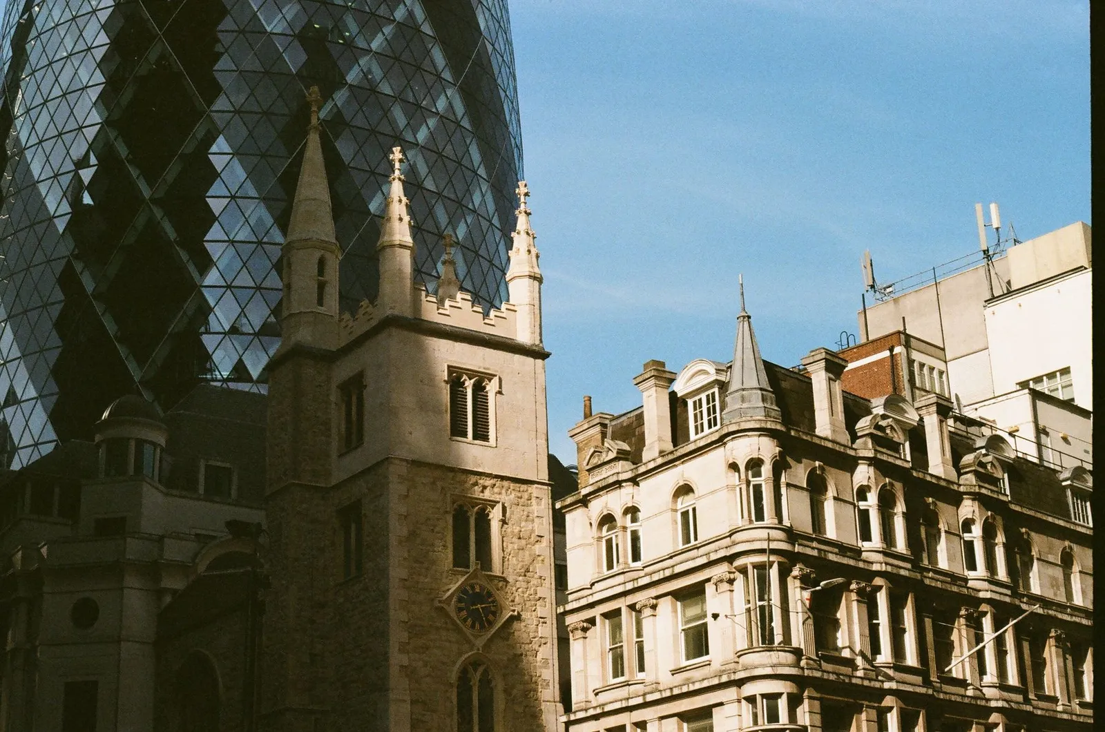 The Gherkin rising behind Victorian buildings in the City of London