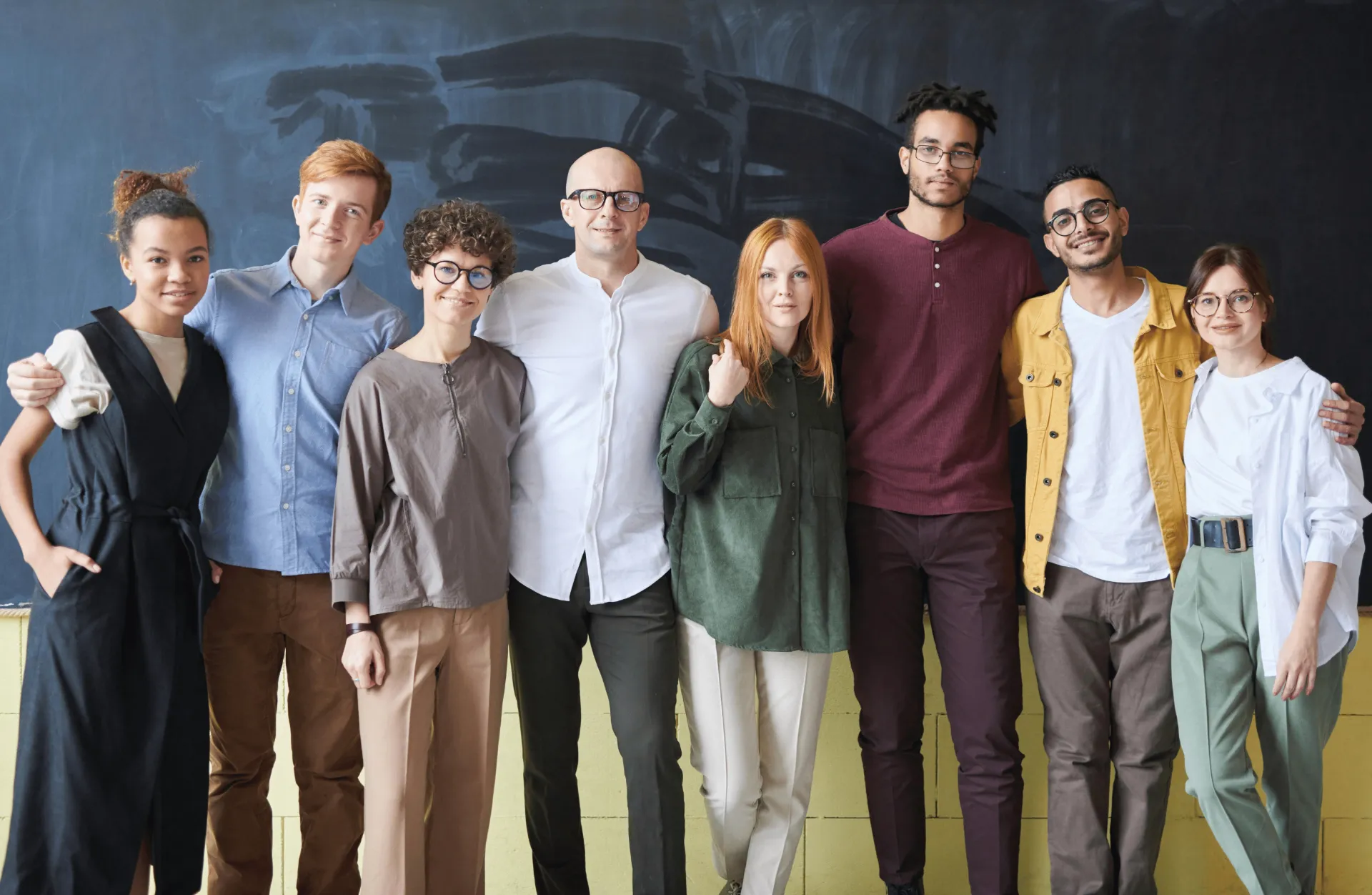 A team of professional website designers and digital infrastructure specialists standing together outdoors in Auckland.