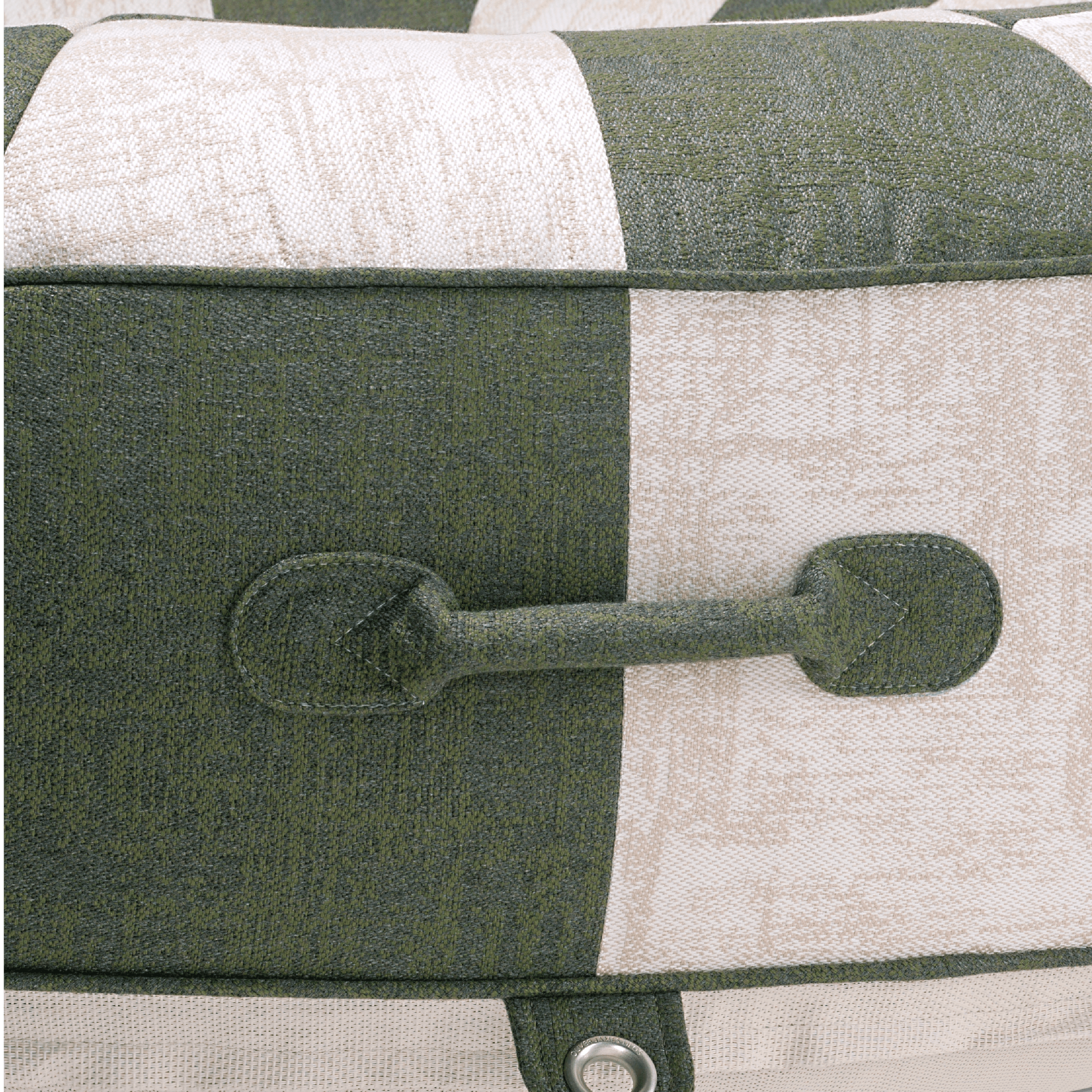 Close-up of pool float showing patchwork jacquard handle, colour-matched stitching, and stainless eyelet