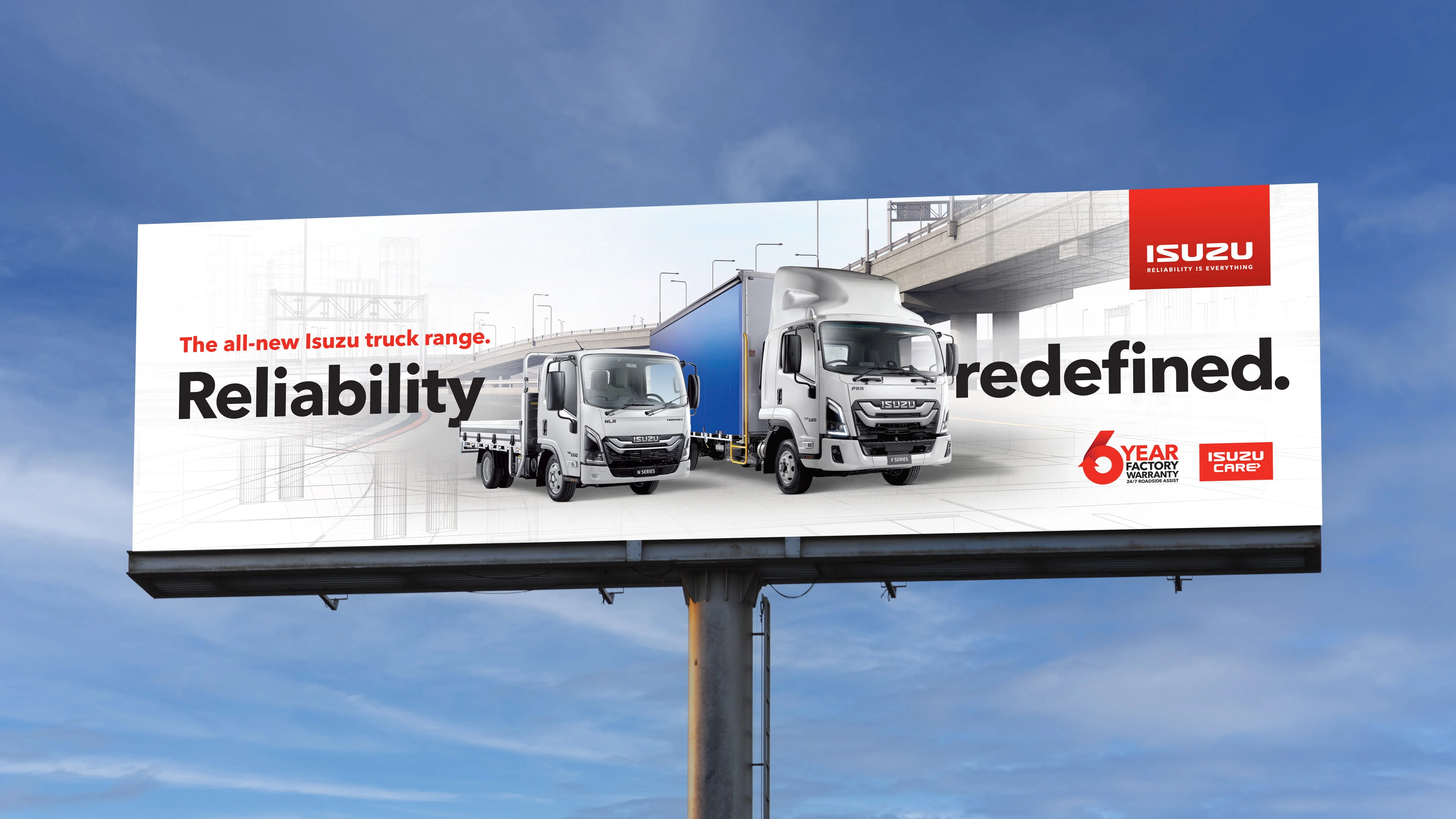 Roadside billboard of two Isuzu trucks headlined 'Reliability redefined.' with 6 Year Factory Warranty and Isuzu Care logos