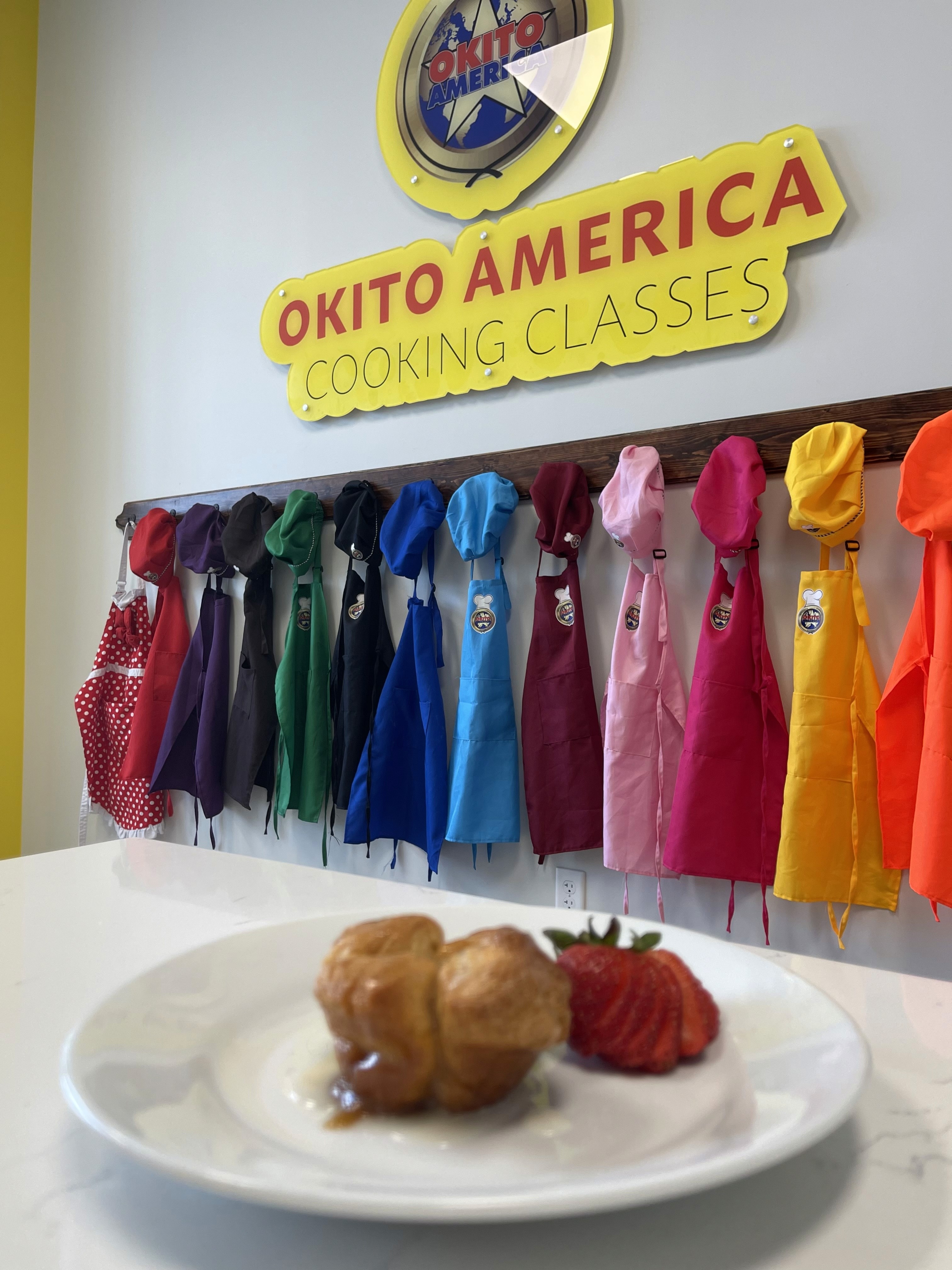 Aprons having in the background with a desert on a plate in the foreground.