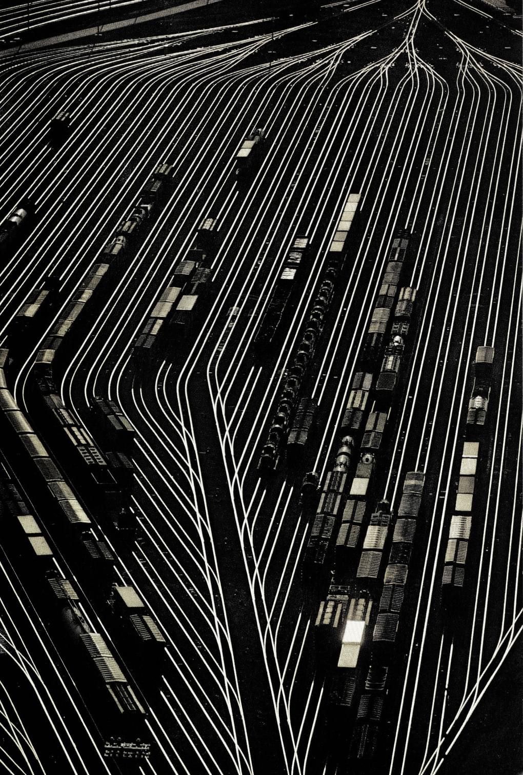 Top-down view of wind turbine over dry terrain with adjacent building