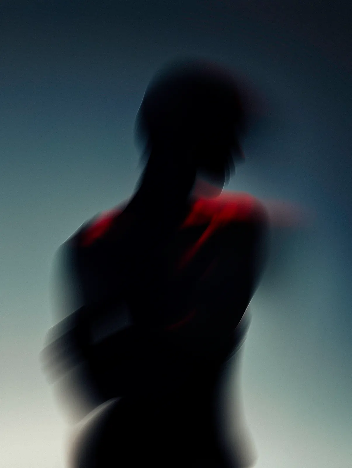 Motion-blurred portrait with a hand raised across the chest in red and blue light.