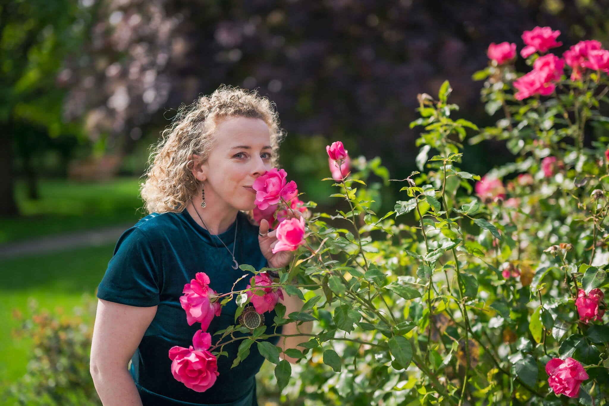 Maryrose smelling flowers