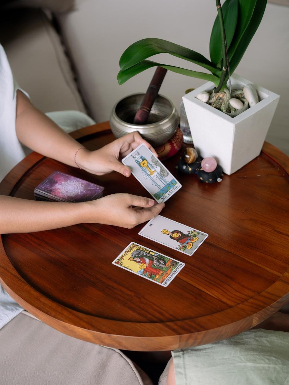 Man in motion during a yoga session in a light-filled modern room with large windows, wood floors, greenery visible outside