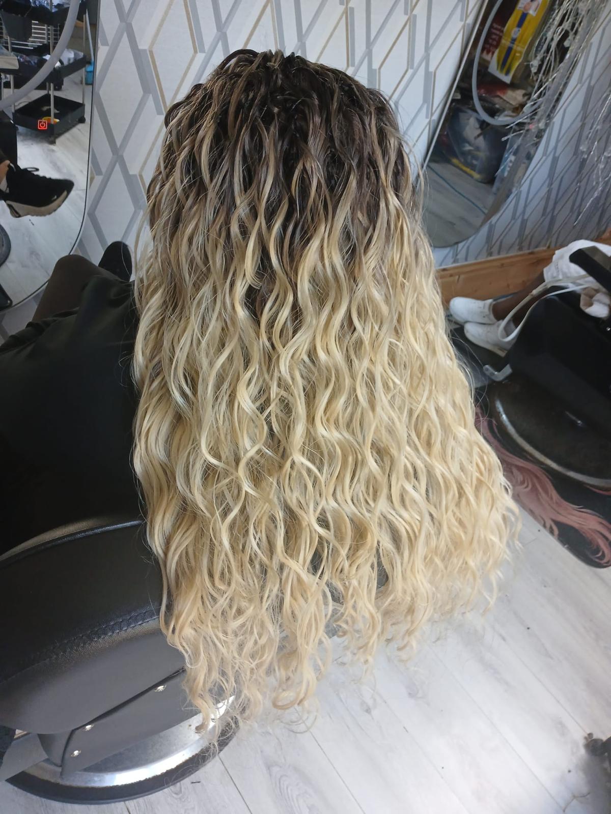 Blonde curly wig with soft volume shown from the back