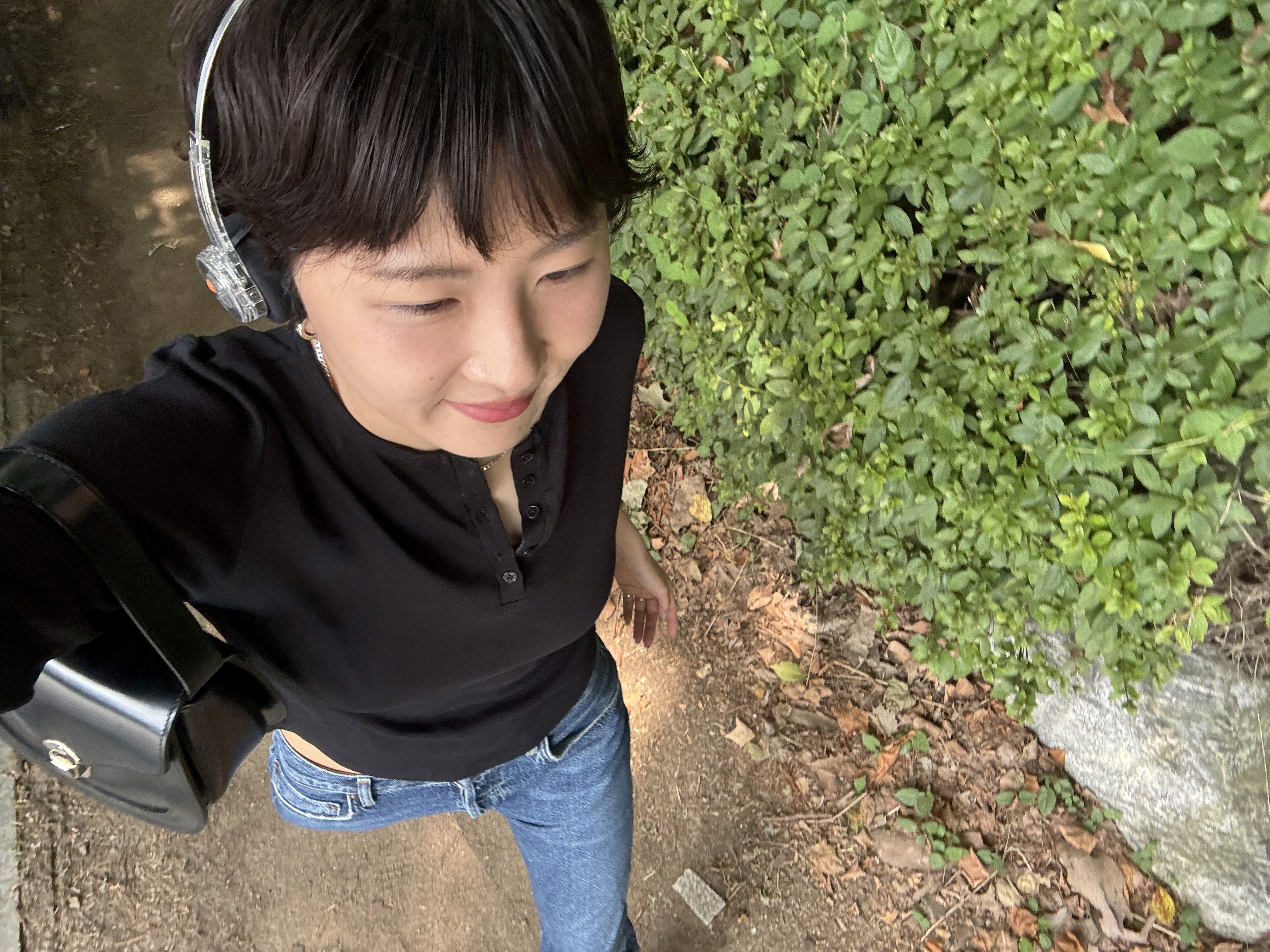 Aerial black and white photo of foamy ocean waves crashing onto a dark sandy beach.