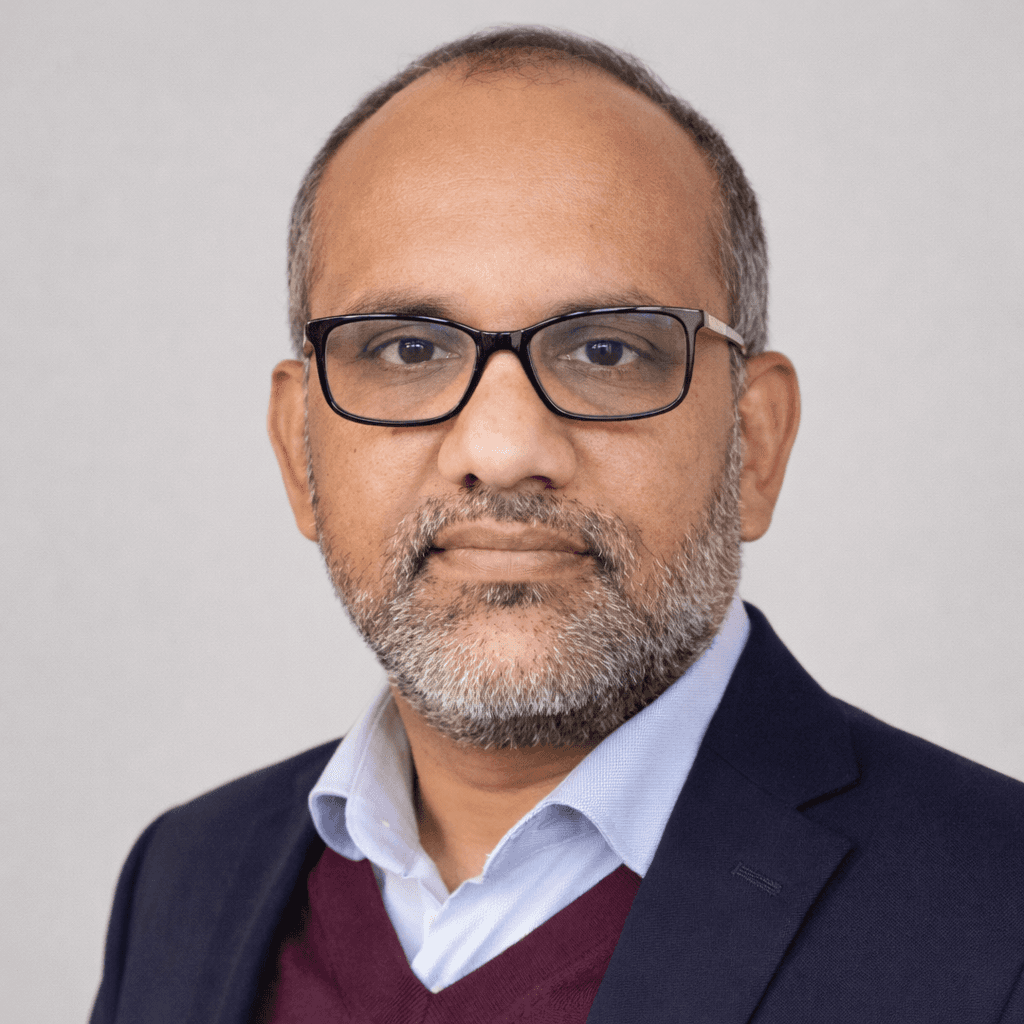 woman in brown long-sleeved top standing beside wall