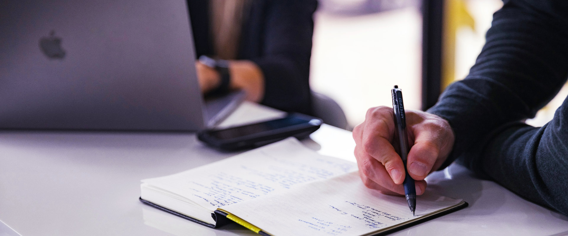 A team of copywriters and journalists writing at a table | Brickers Foundation