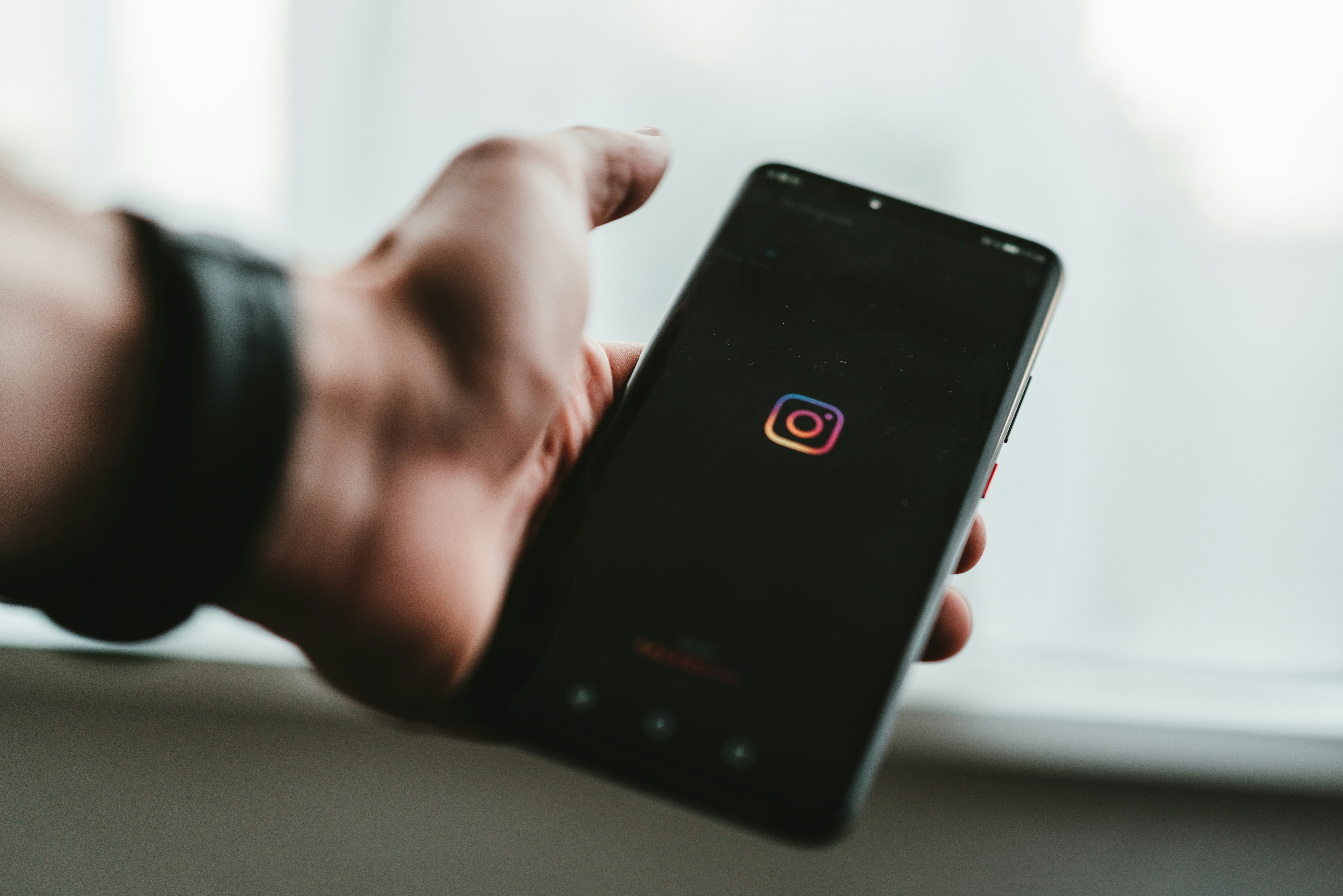 person with instagram app in hand - Instagram Monetization