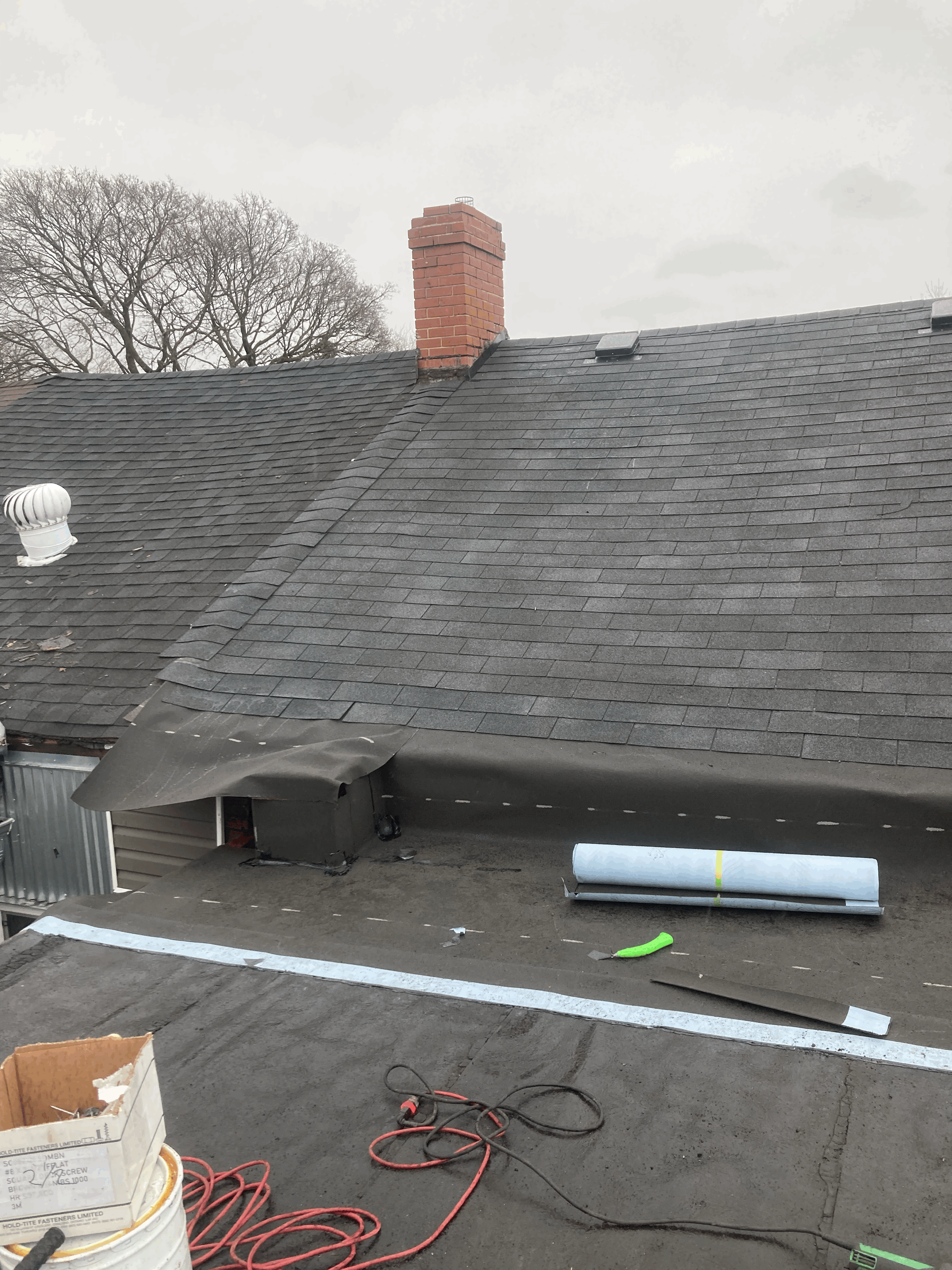 Asphalt shingle tear-off and underlayment installation during a professional roof replacement on a residential property in Scarborough