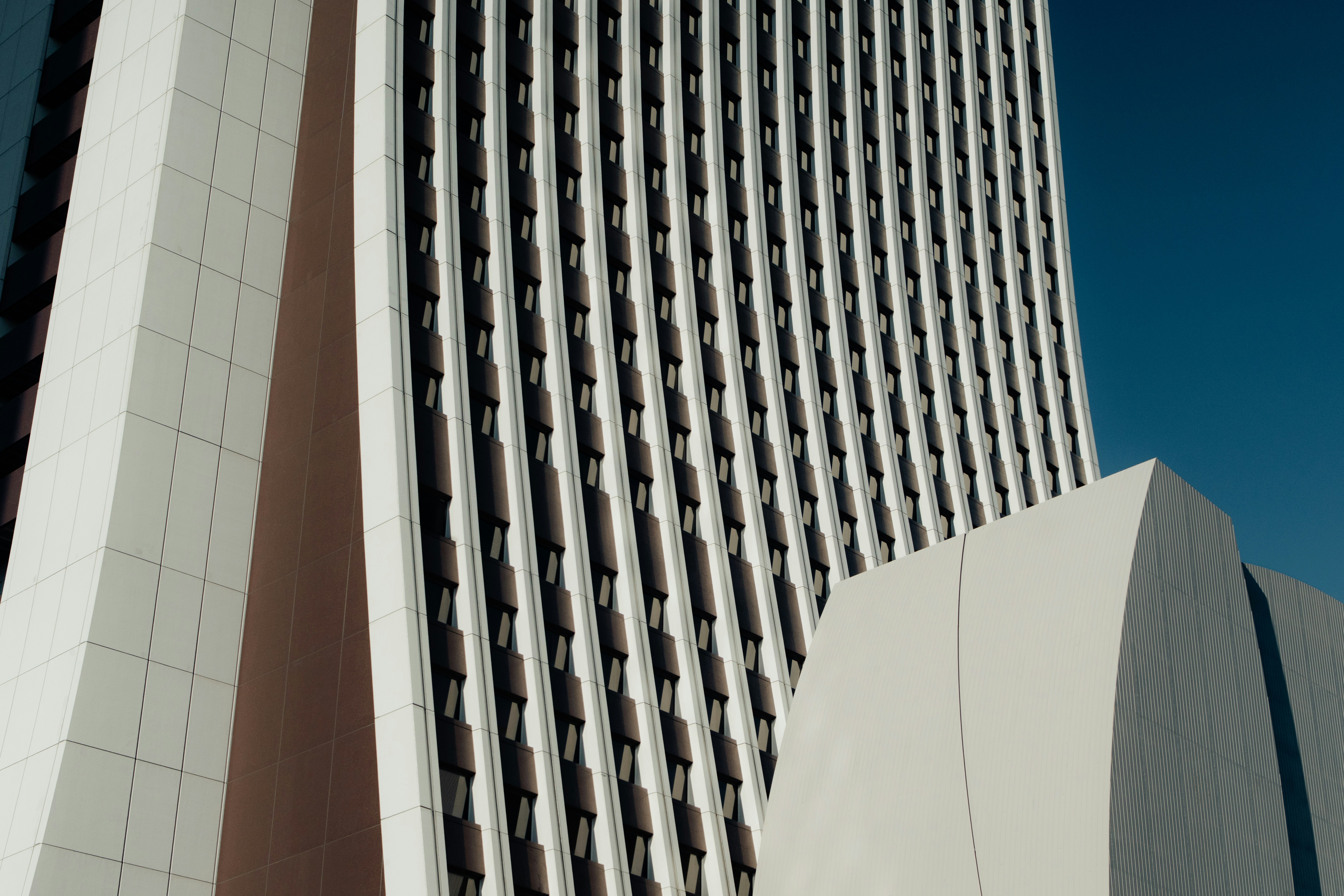 Modern white building against a clear blue sky