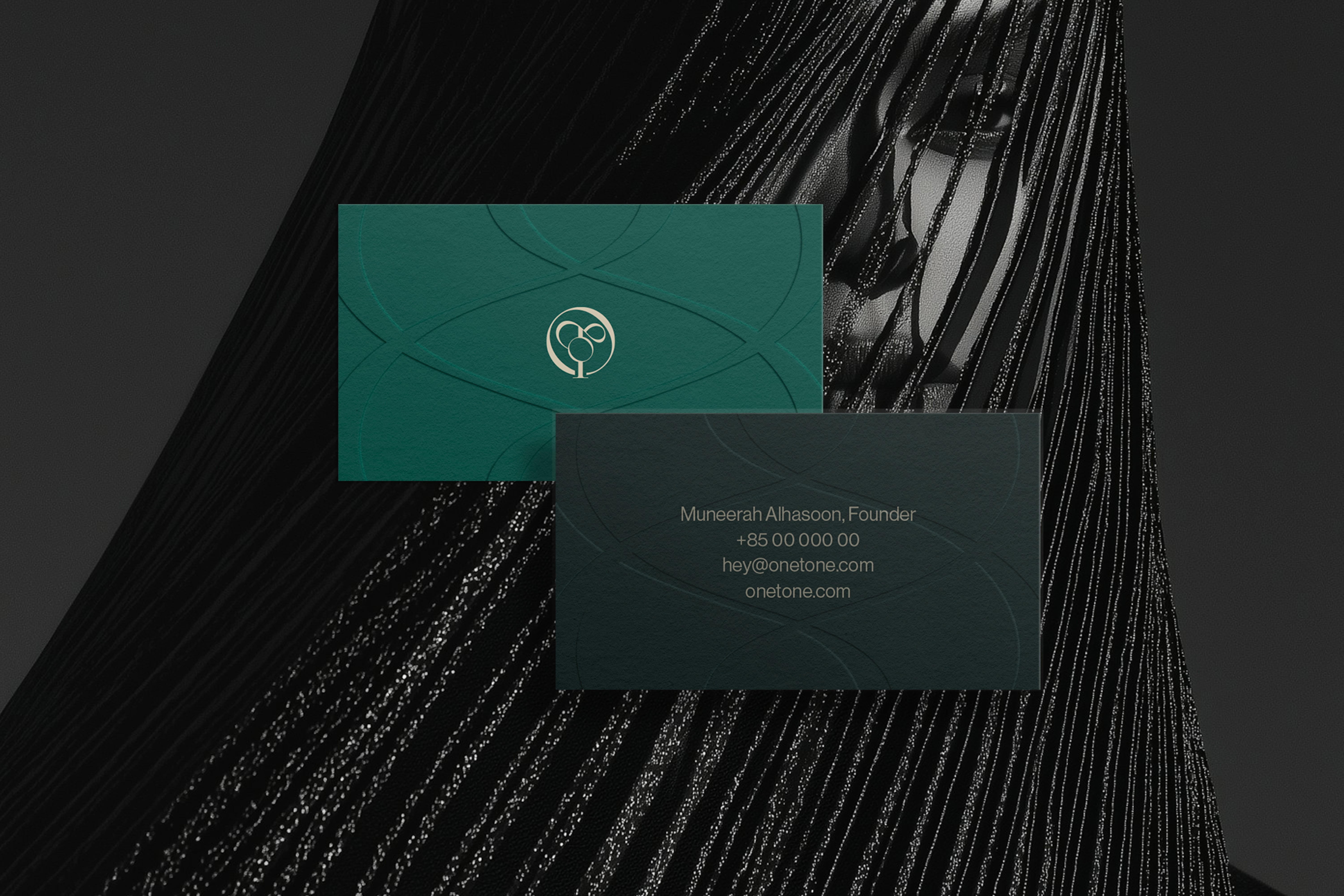 Minimalist business stationery design – Deep green branded envelopes and business cards with gold embossed details, representing Onetone’s luxury aesthetic.