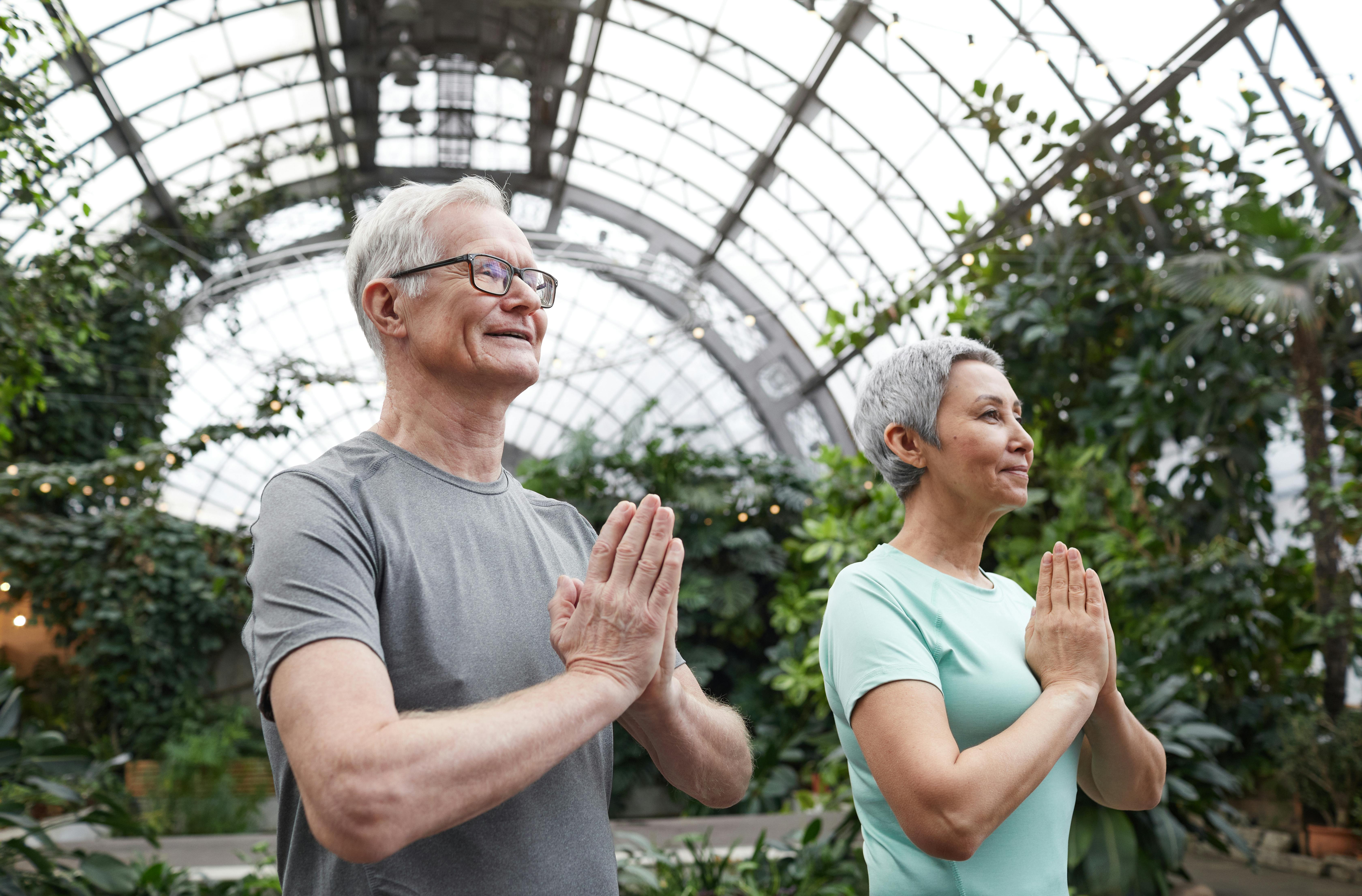 Elderly couple holding hands and smiling