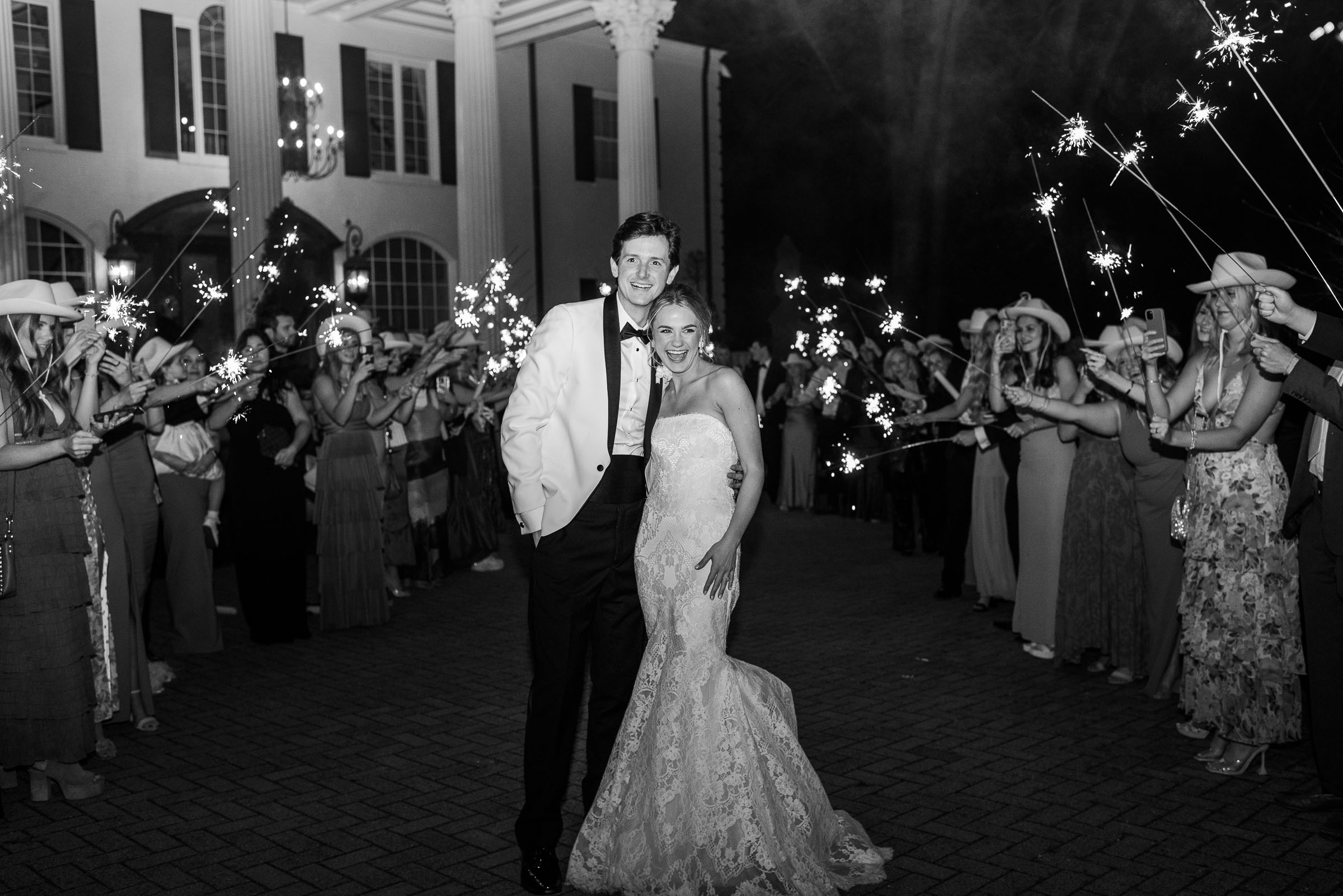 The bride and groom’s sparkler send-off at The Estate at Cherokee Dock captured in black and white photography.