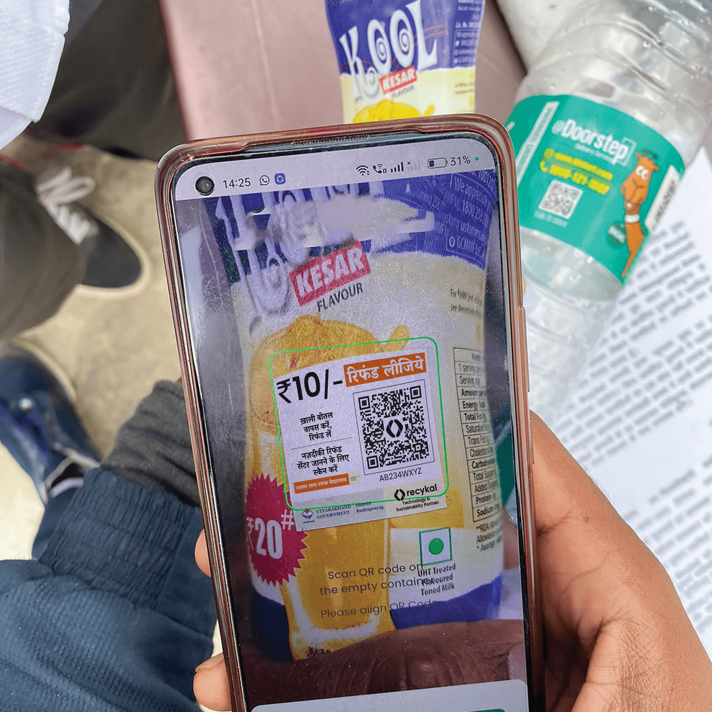 Woman in red outfit poses by a red telephone booth.