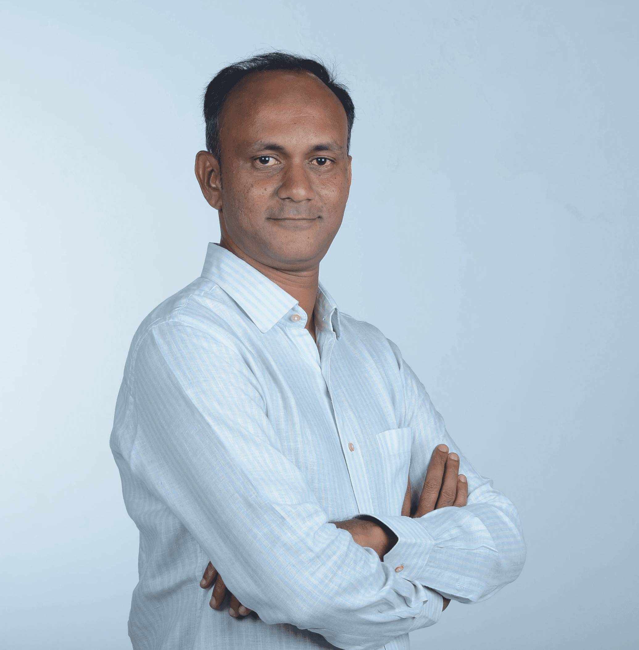 Profile portrait of a man in a white shirt against a light background
