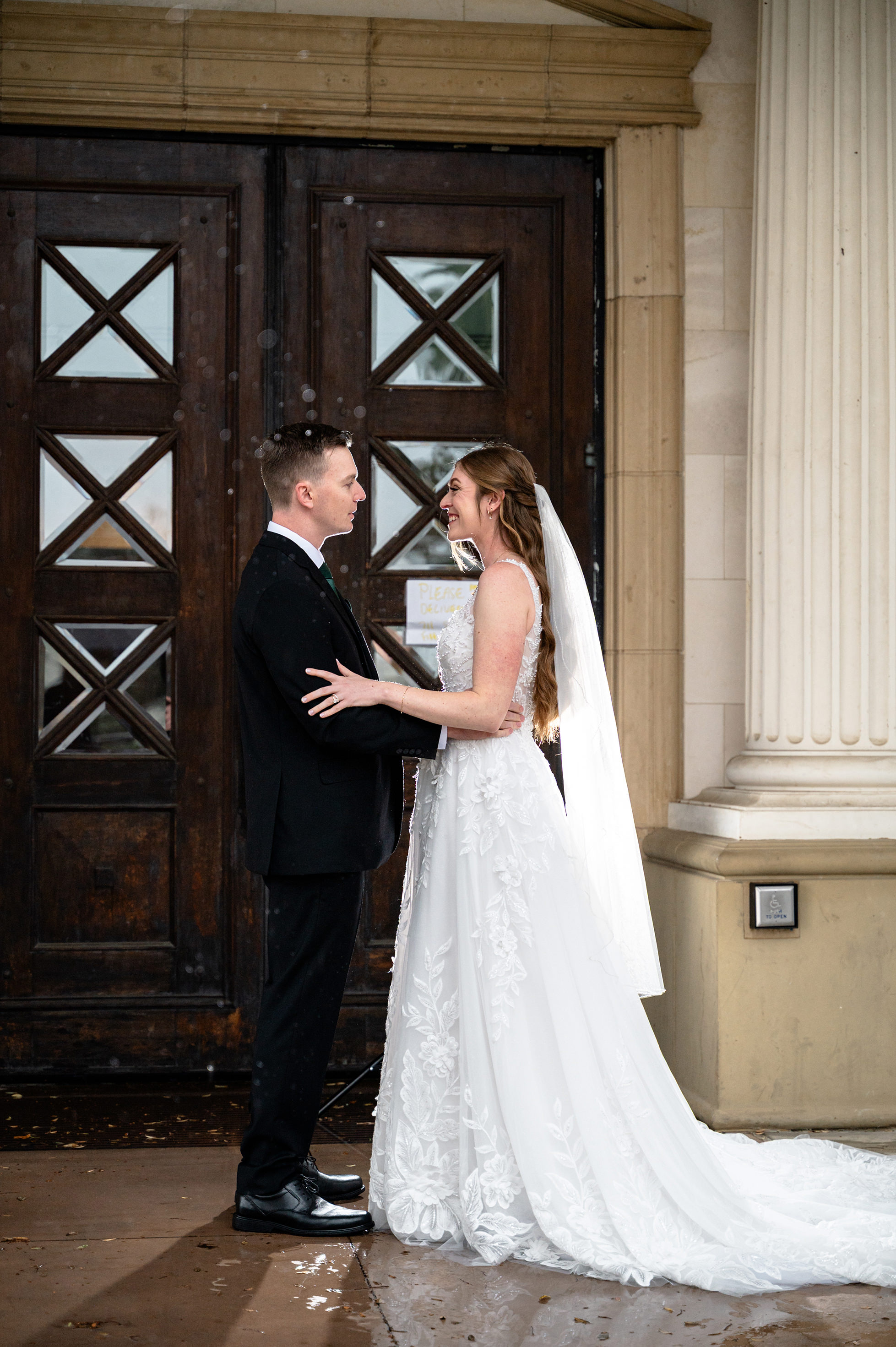 Flat lay wedding details with bouquet, rings, and sparkling bridal heels