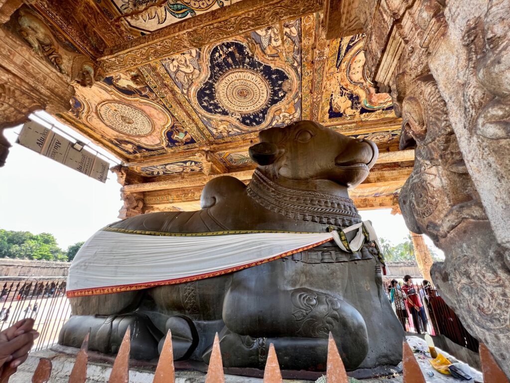 The monolithic Nandi with the ornate mural ceiling at the Brihadeeshwara temple of Thanjavur.