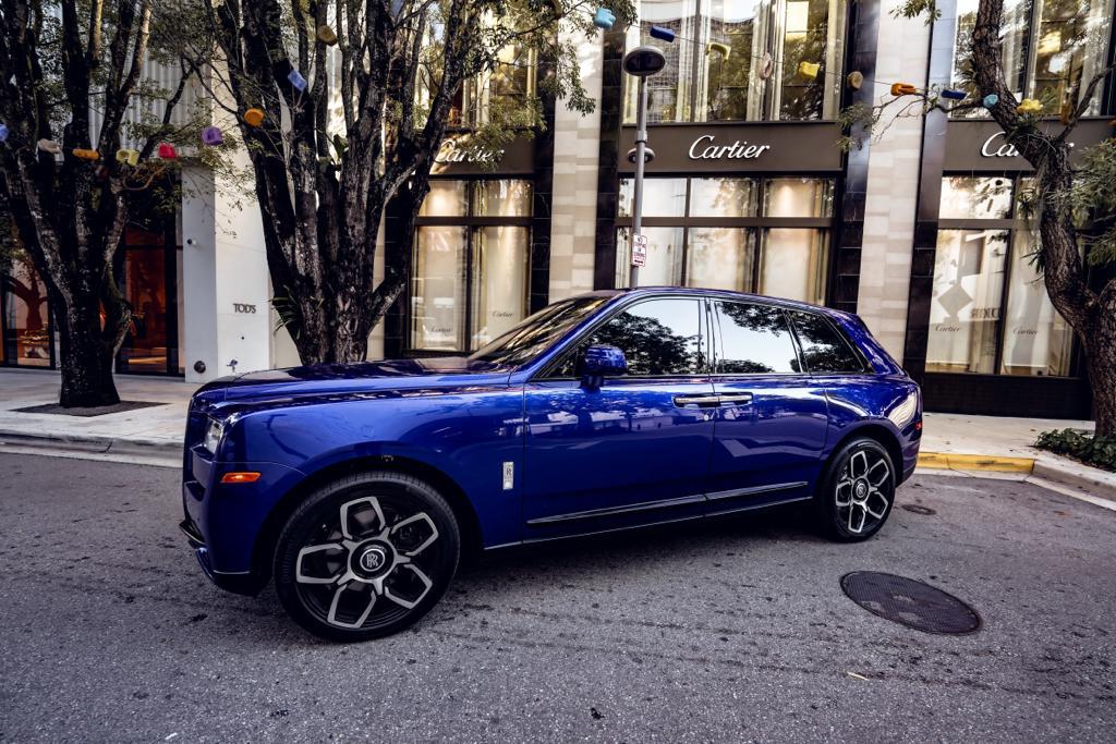 Rolls-Royce Cullinan in metallic blue finish showing full side profile, highlighting luxury SUV proportions and distinctive design elements