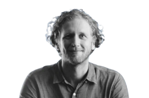 Headshot of a smiling man in black and white