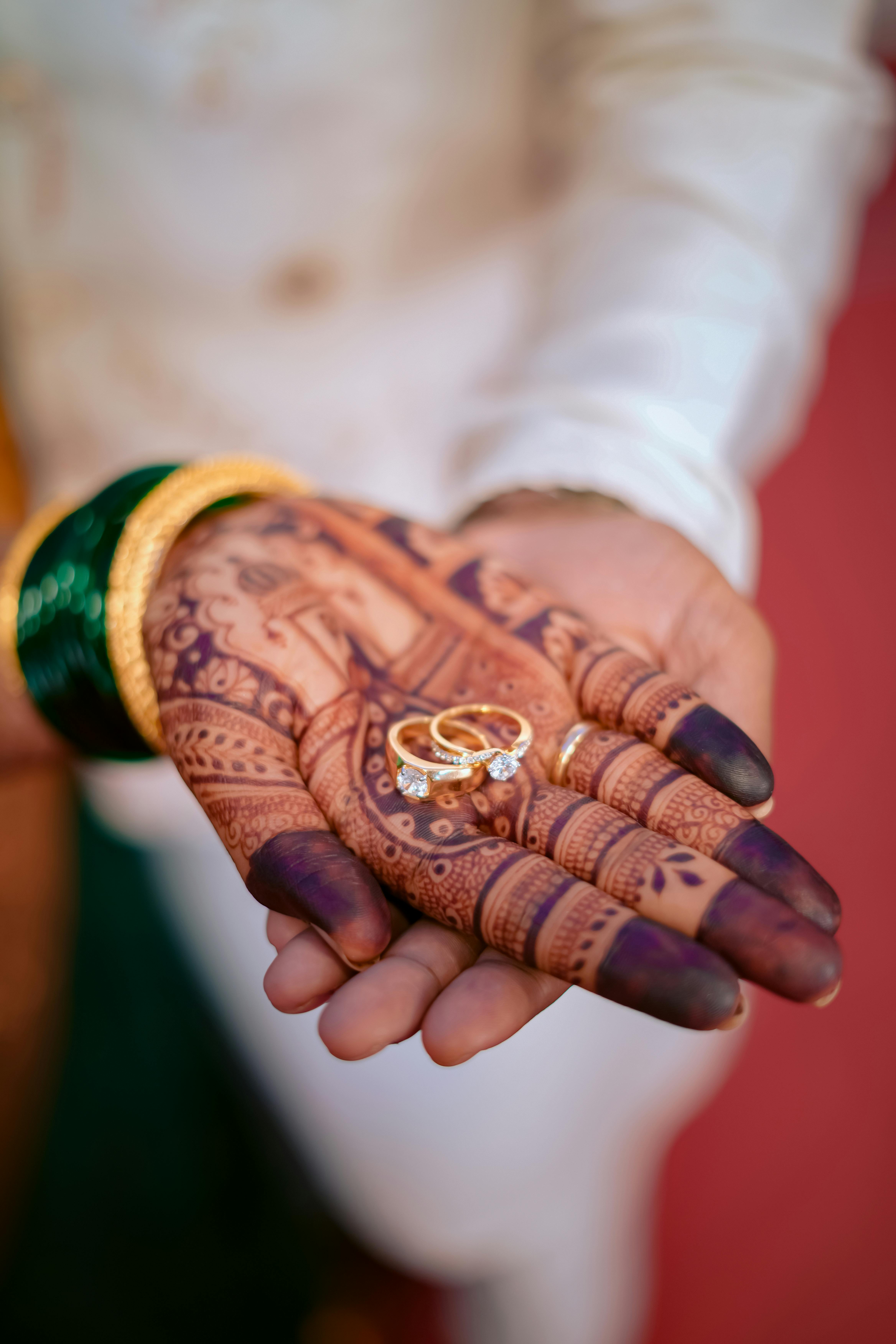 A bride and groom share a kiss surrounded by a joyful bridal party.