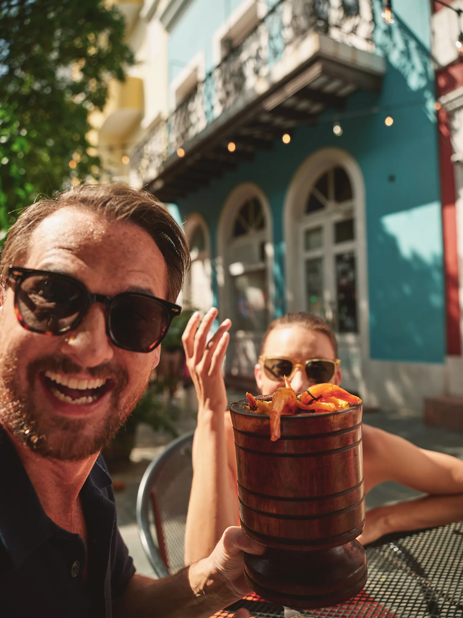 man laughing with shrimp cocktail selfie — lifestyle photography by Tom Kubik