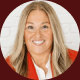 Headshot of a smiling woman with long blonde hair wearing glasses and a white top