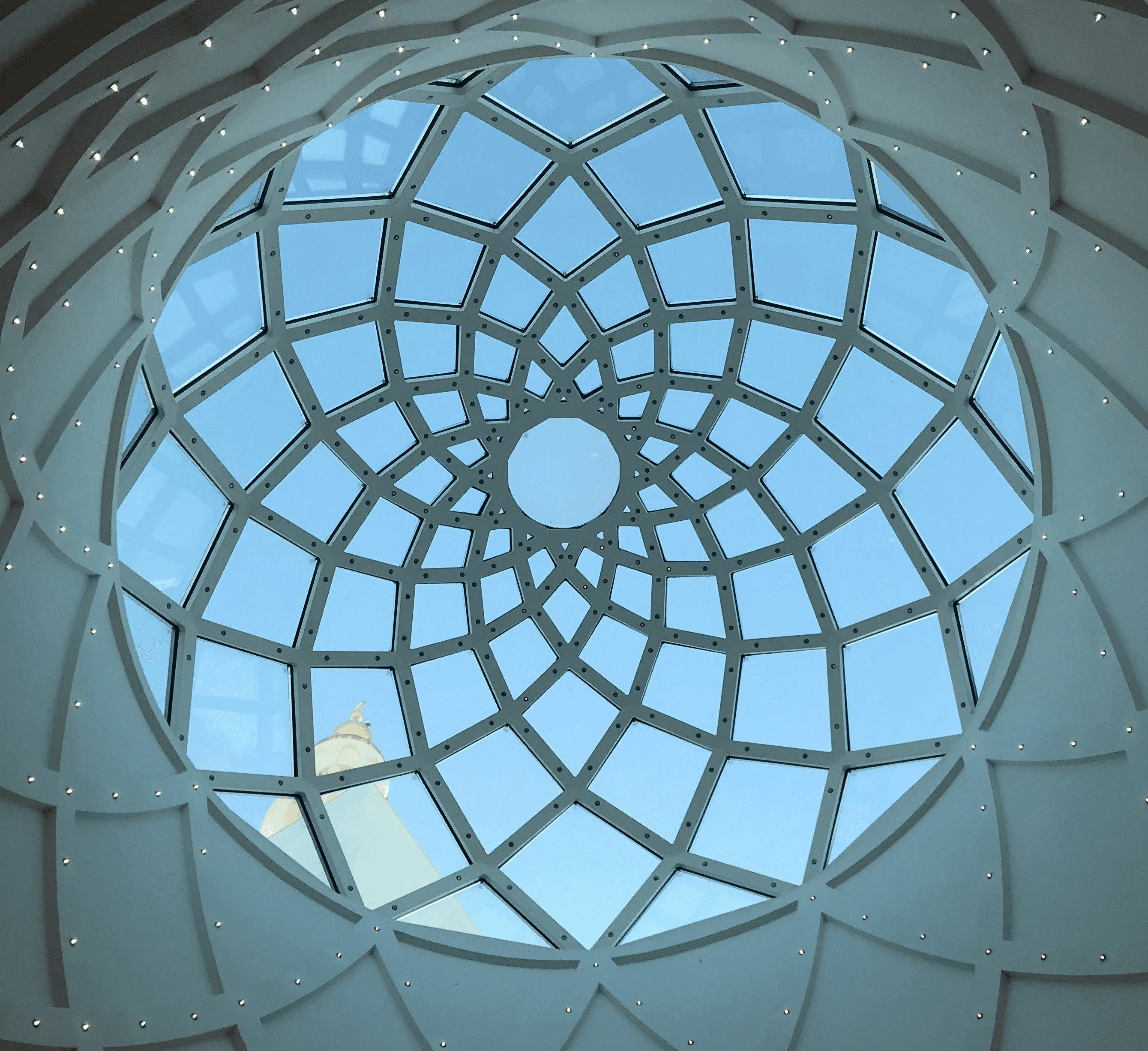 a circular window with a sky view of a building