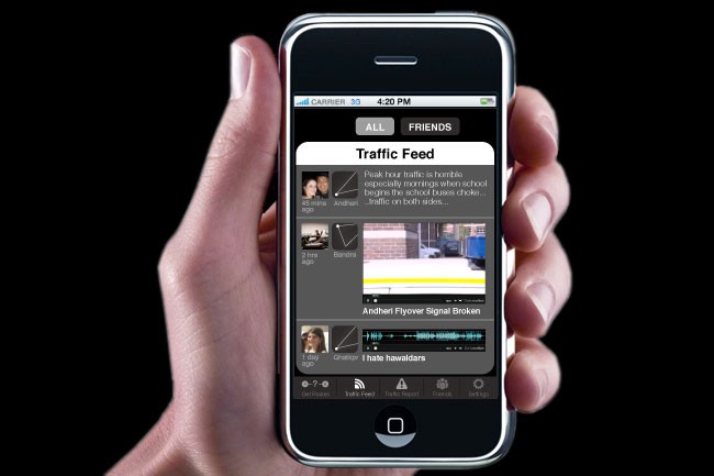 A hand holds a black iPhone displaying the Traffic Feed app. The screen shows several posts: one from "Andihan" at 2 hours ago, another from "Bandra" at 2 hours ago, and a third from "Chatting" at 1 day ago. The top of the screen displays "ALL" and "FRIENDS." The carrier is 33, the time is 4:20 PM, and the carrier signal is strong. The background is black.