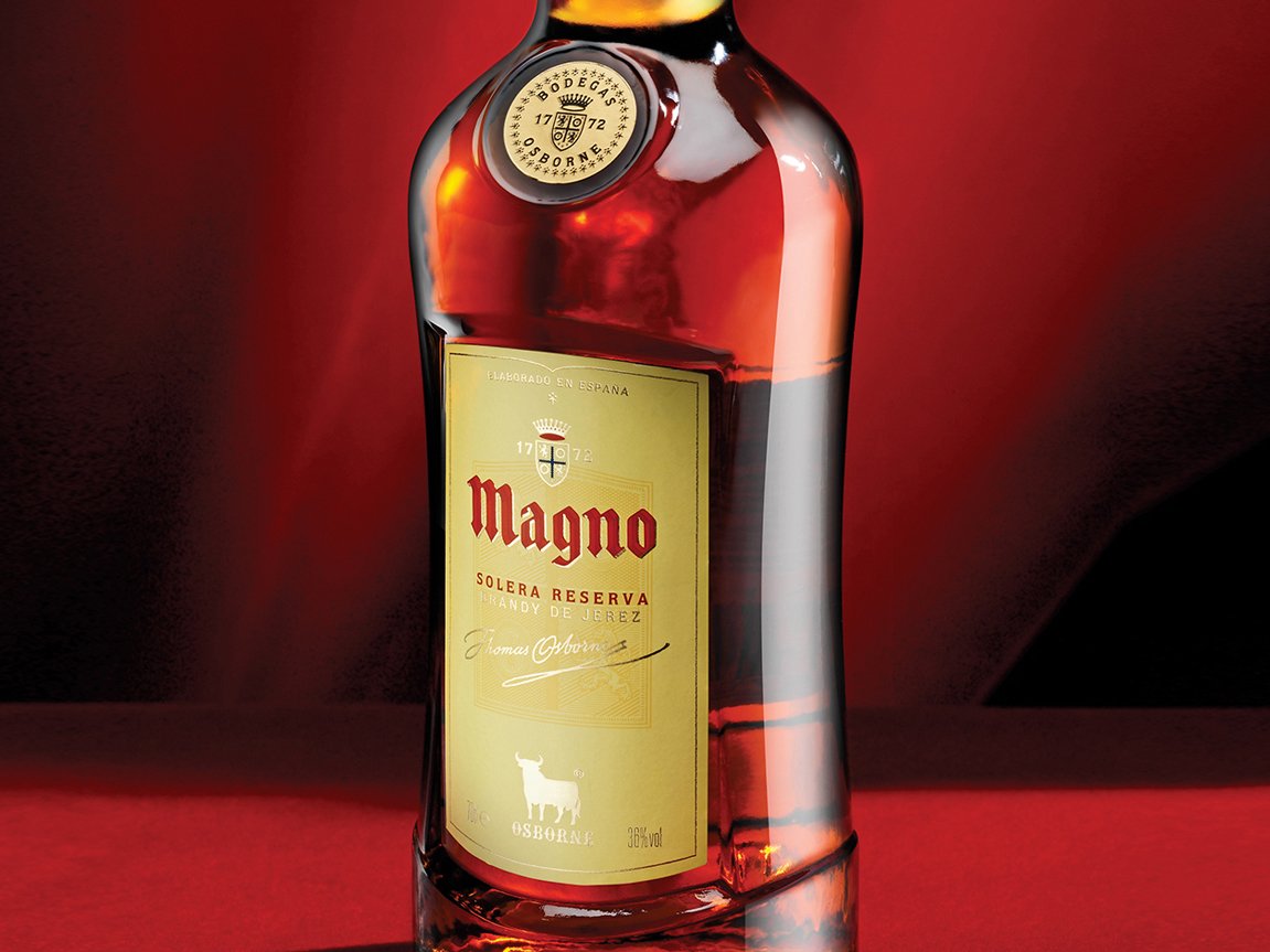 Rustic cabin in a golden field at sunset