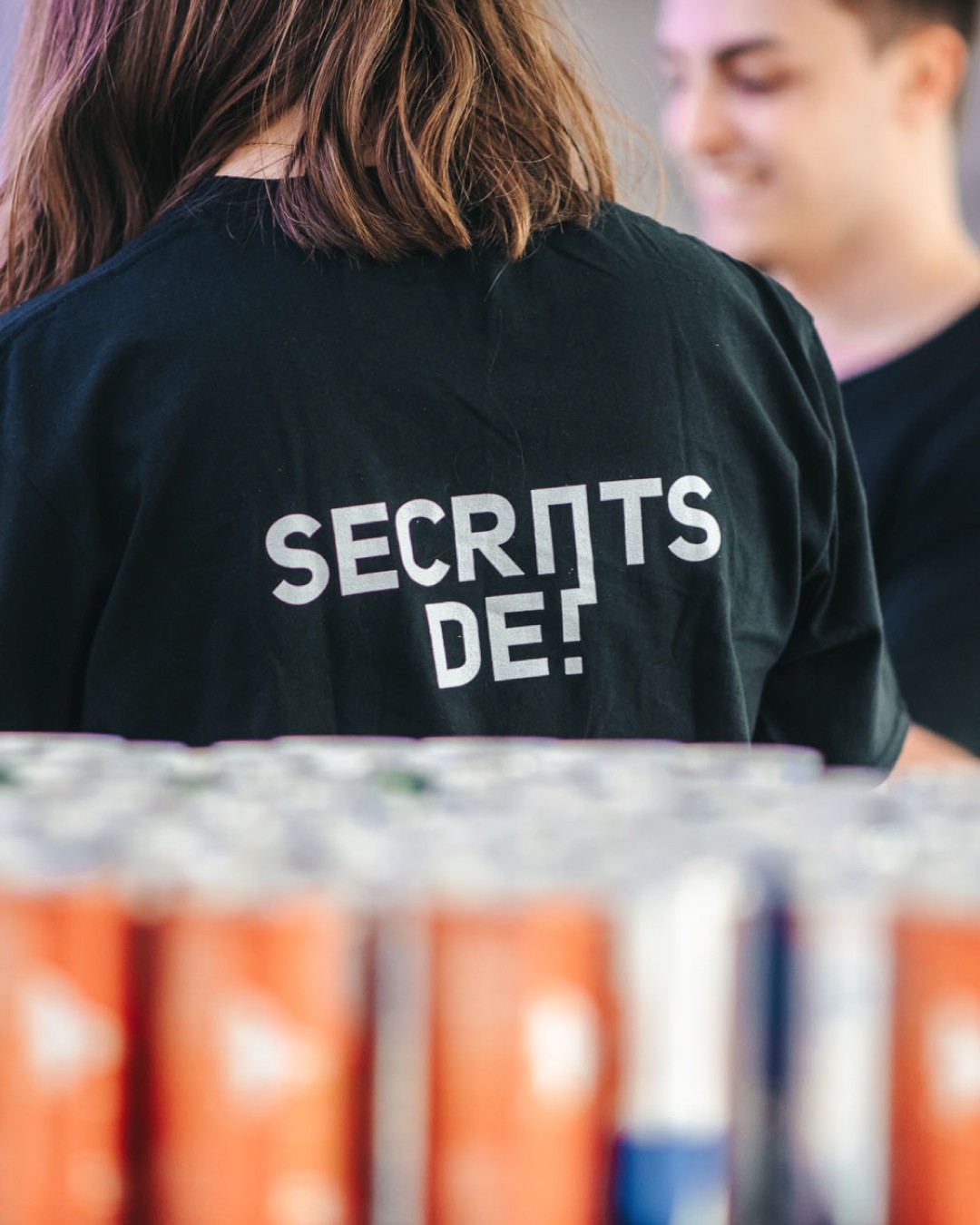 Modern home office setup with a monitor, ergonomic chair, keyboard, and indoor plants near a window with blinds.