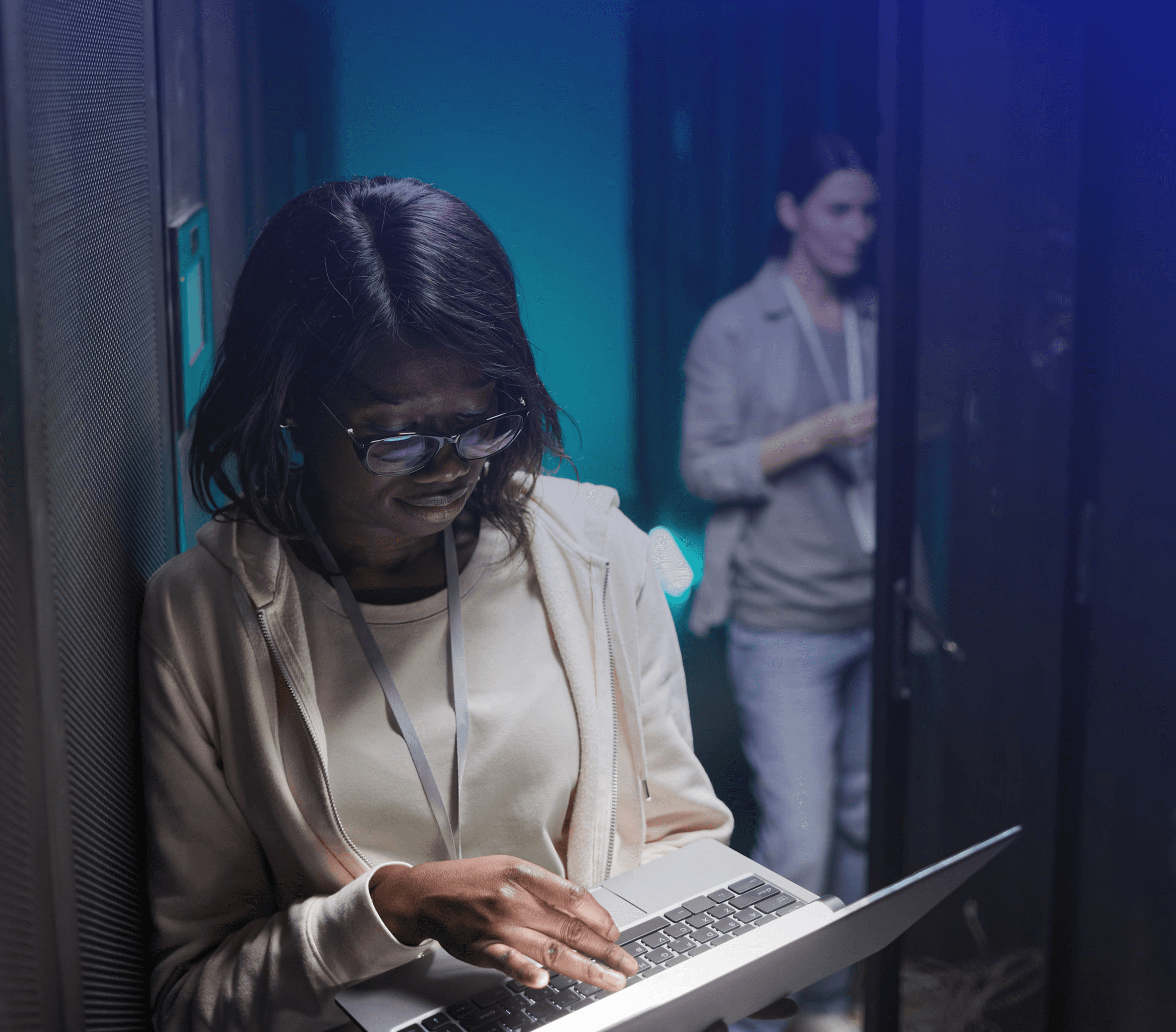 Woman holding laptop in data center