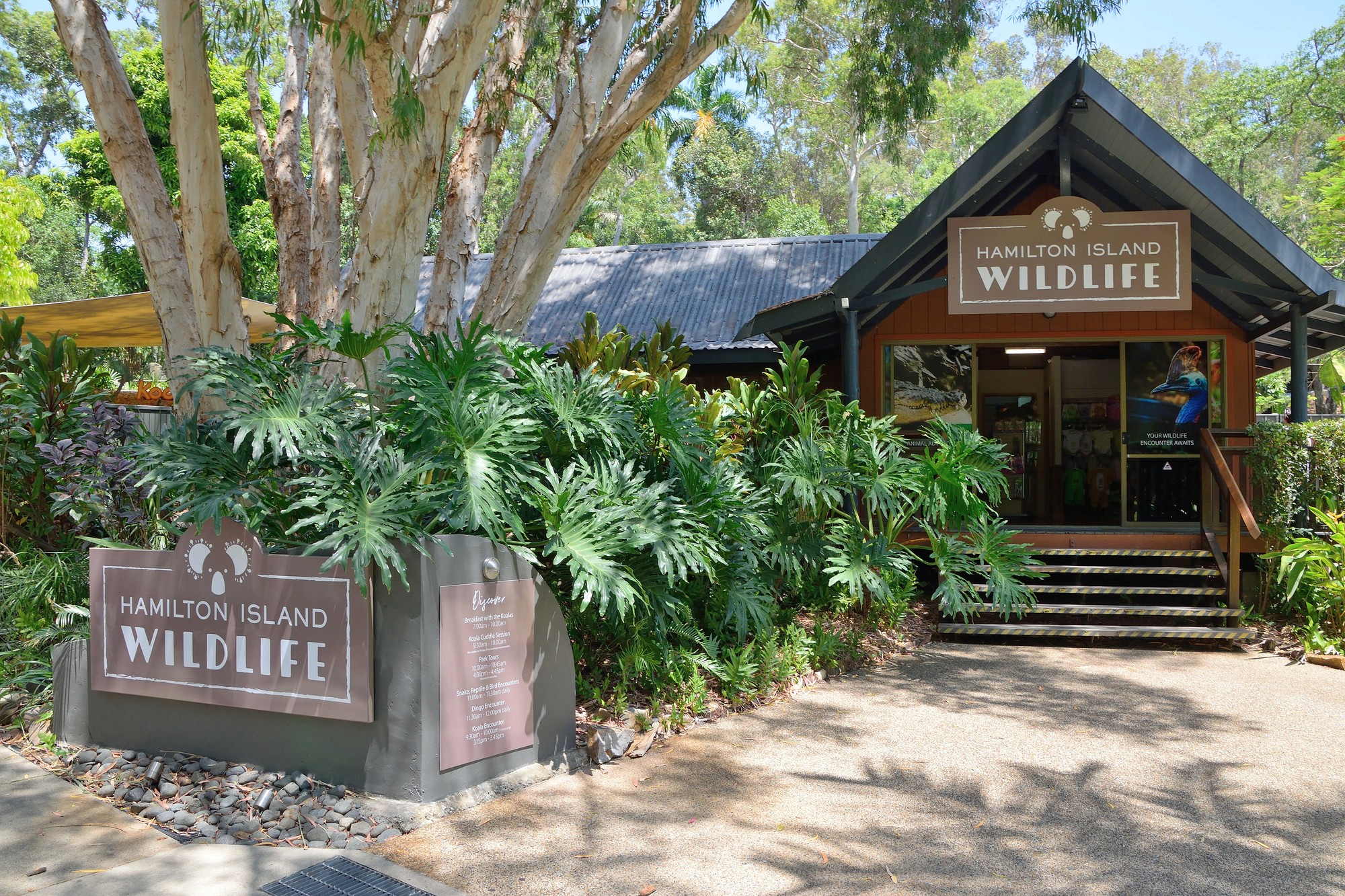 a large building with a statue in the middle of a garden