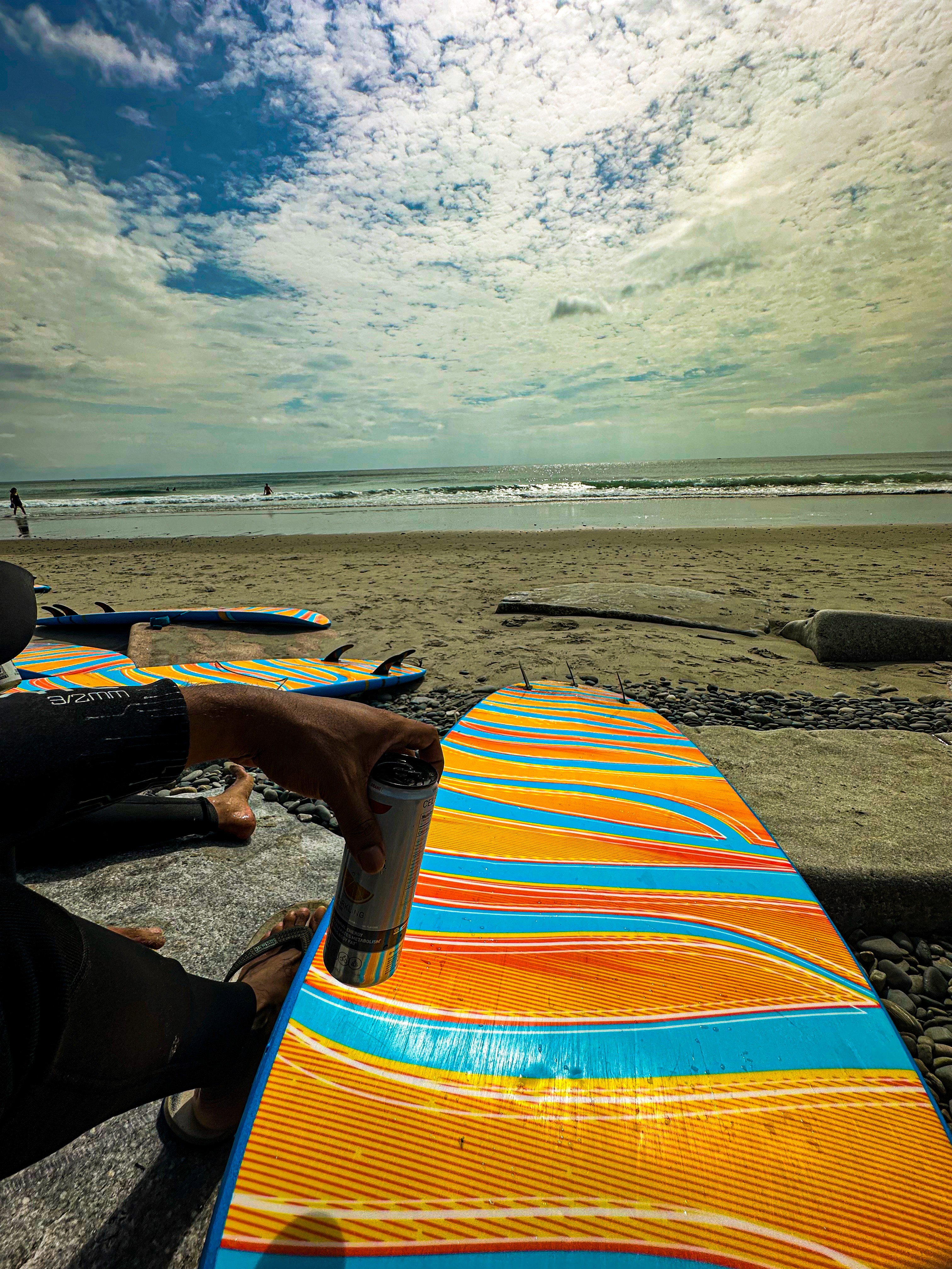 Close-up of a yellow tennis ball sitting on a green court, positioned near the white center line.