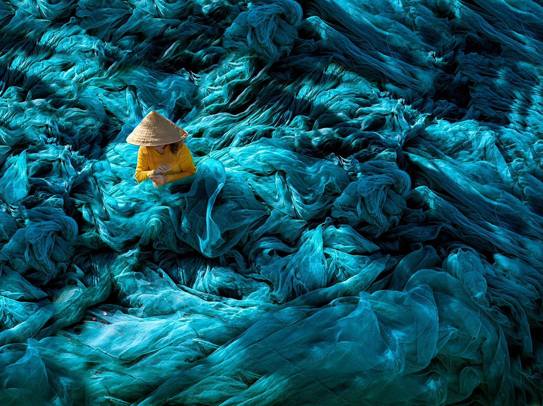 The Hidden Grace of a Vietnamese Woman Mending Nets