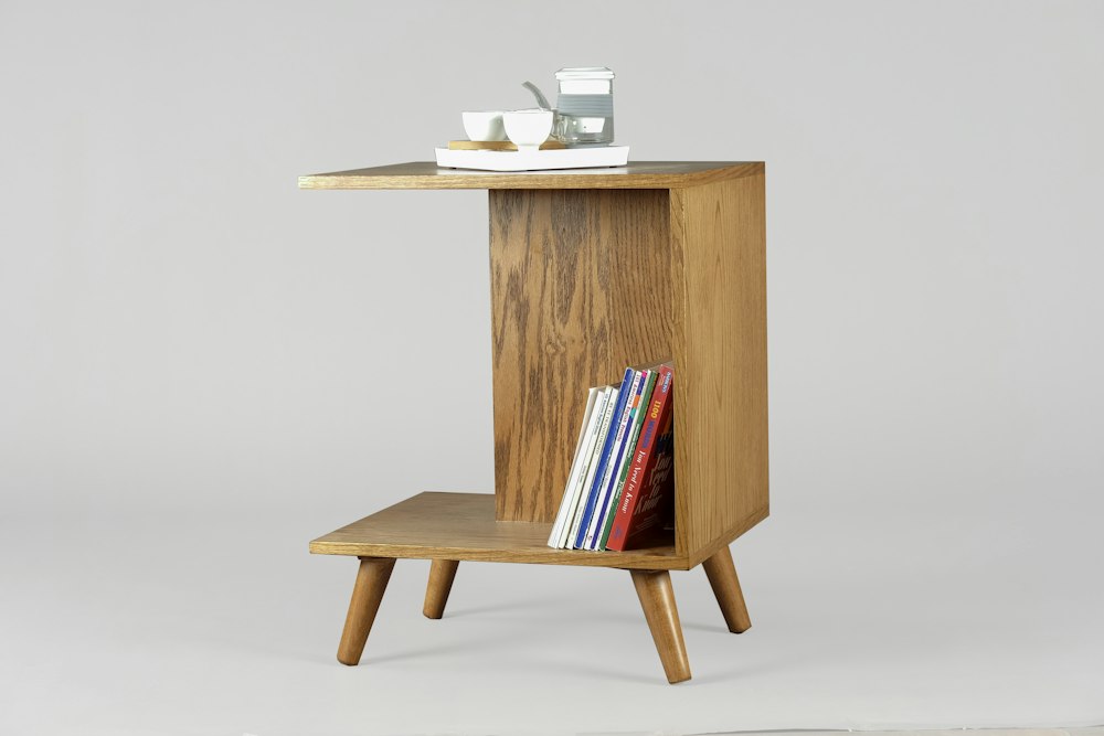 Solid wood side table with books and mugs