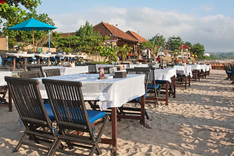 Beachfront dining area in Jimbaran, Bali, perfect for property buyers seeking lifestyle.