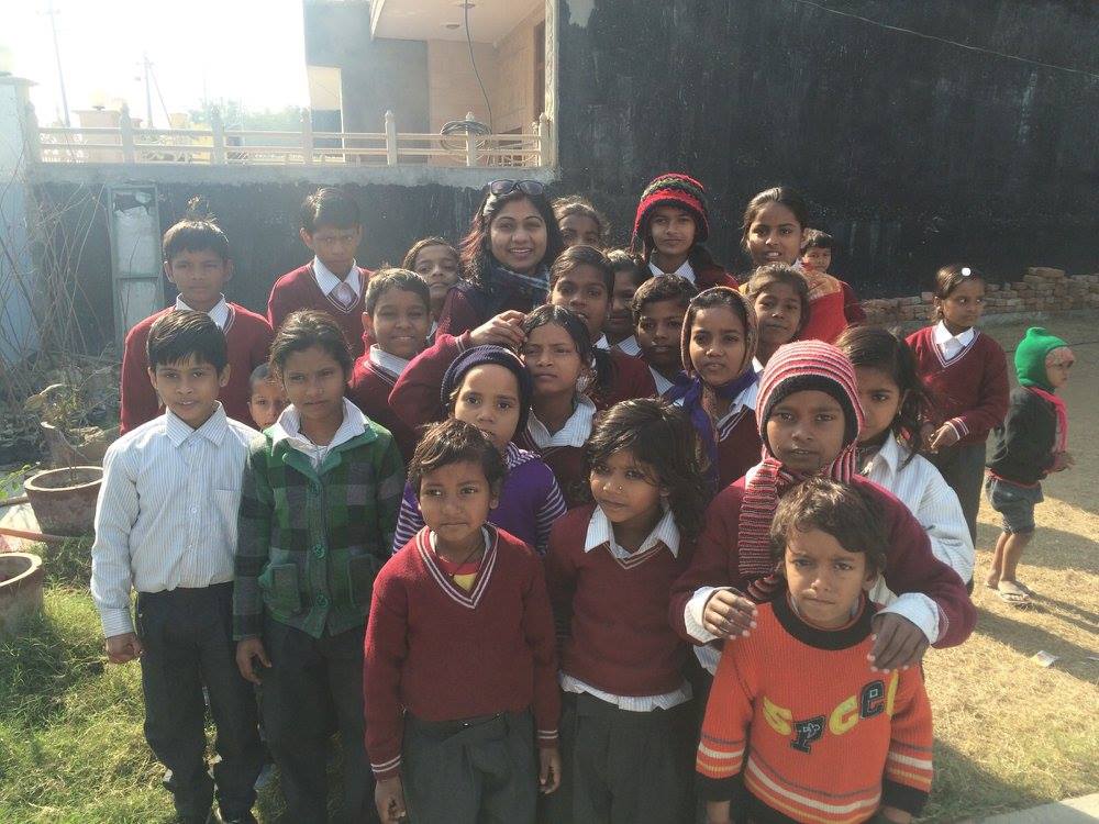 group of women in red and white dress standing on brown wooden bar during daytime