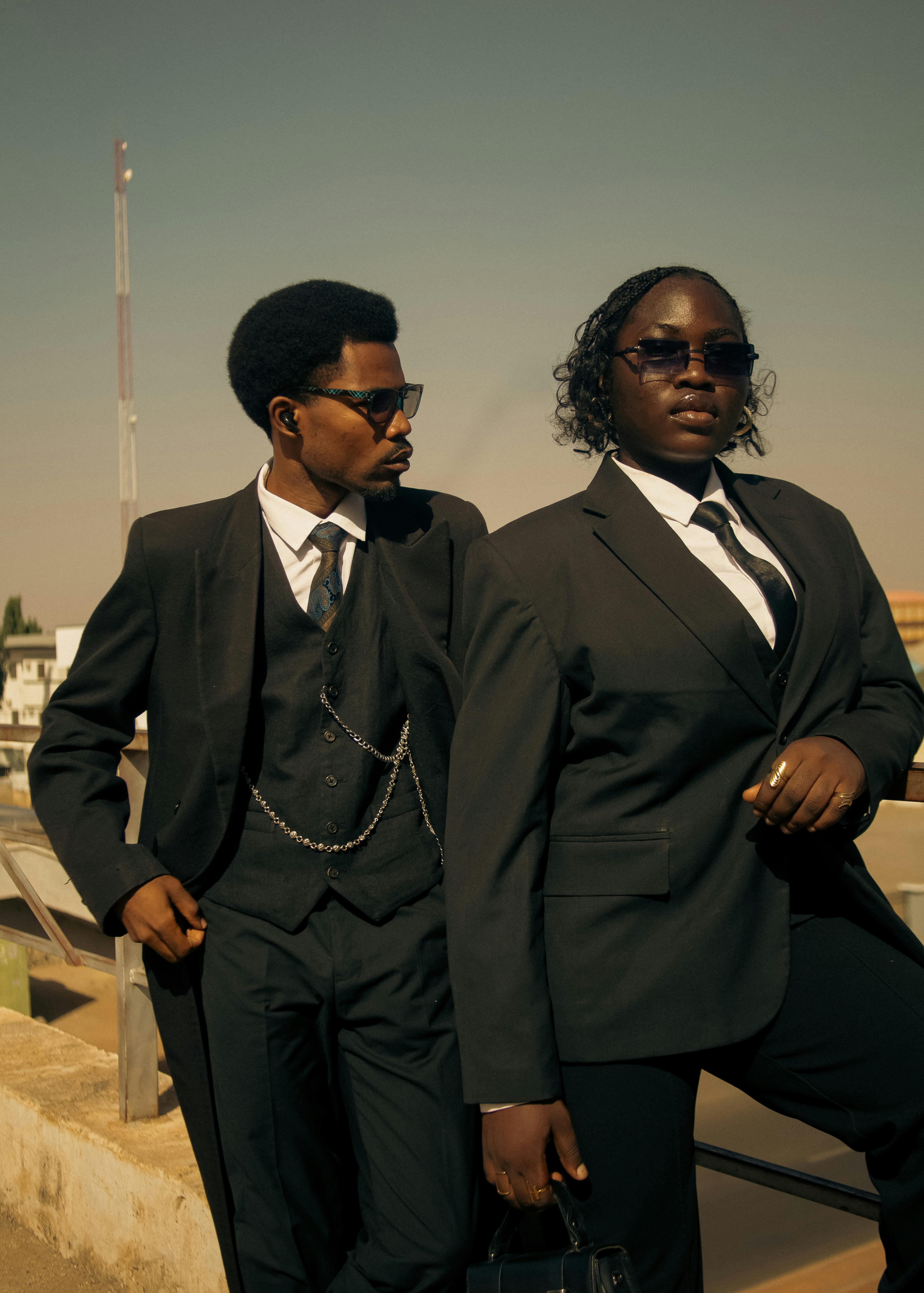 two-individuals-in-suits-posing-confidently-outdoors-under-clear-skies,-showcasi - lekepov (pexels)