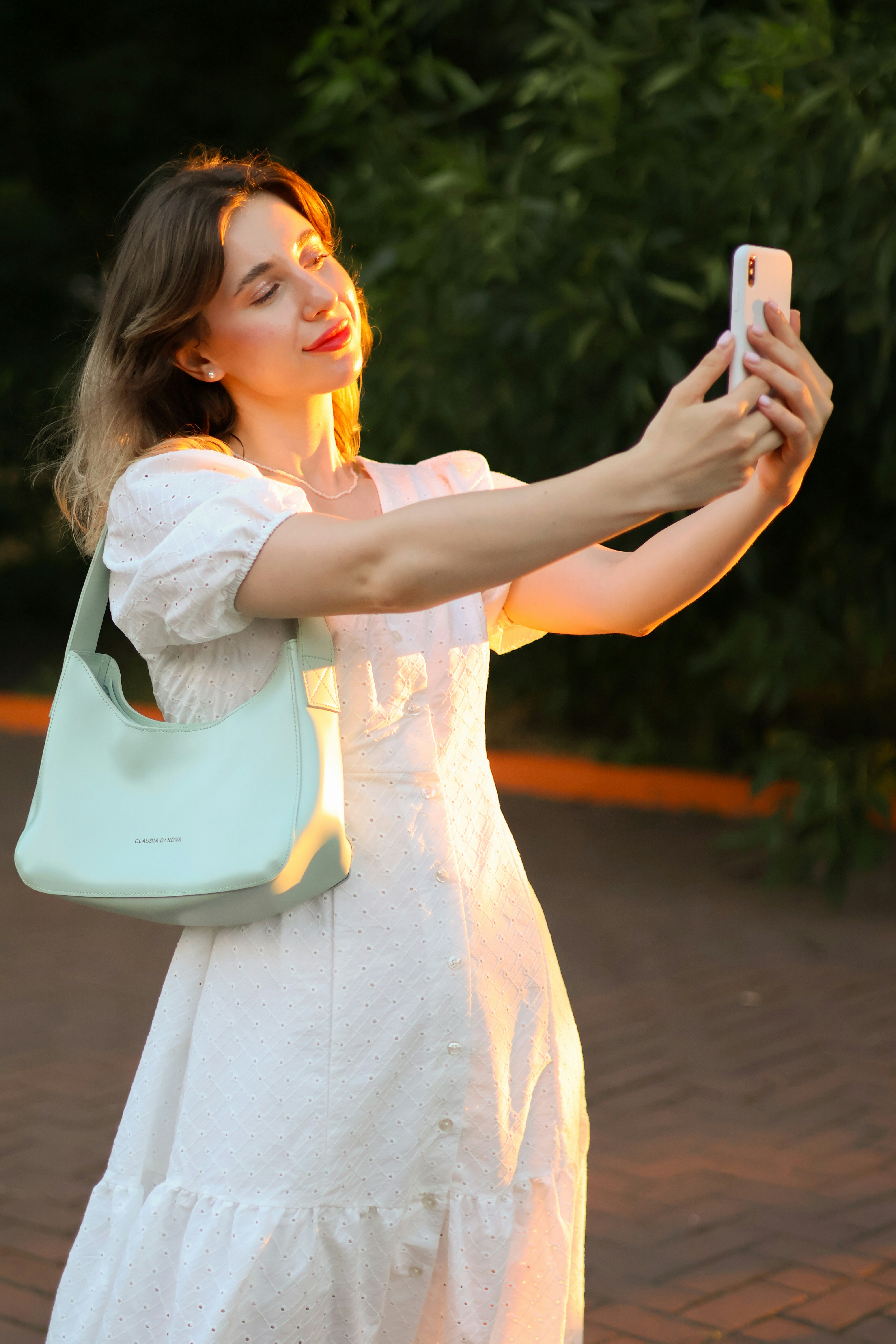 a woman taking a picture with her cell phone