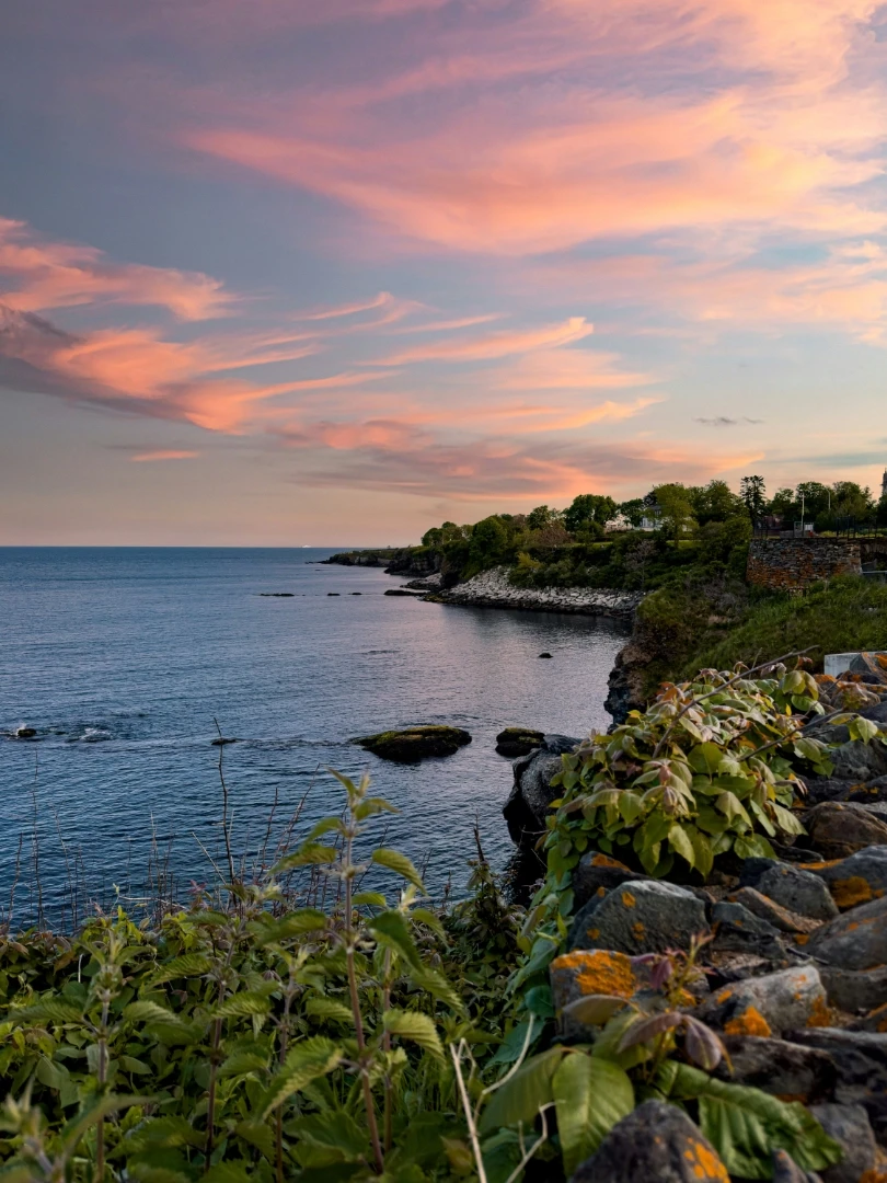 A view of a Newport coastastline at sunset.