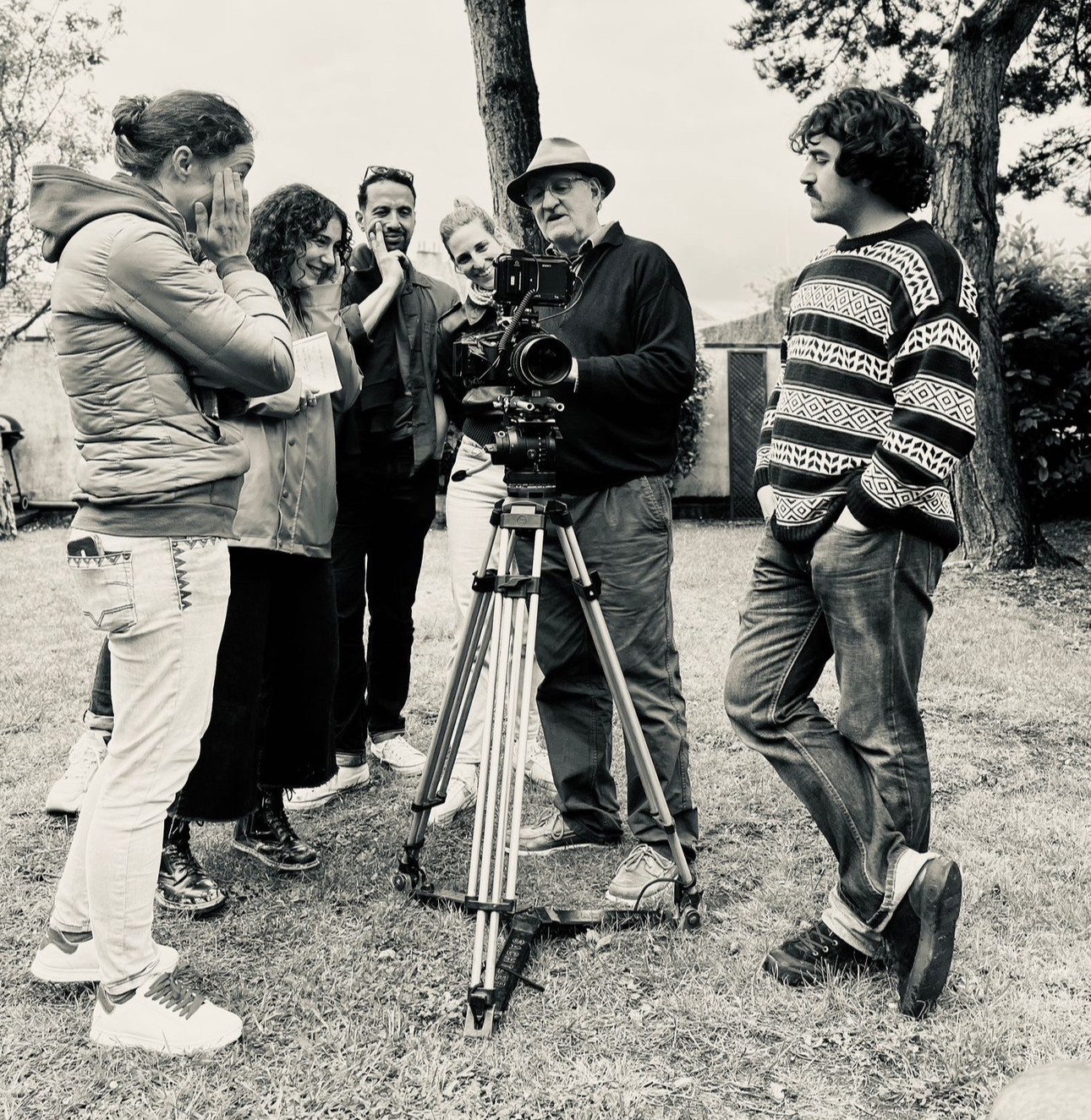 woman in white long sleeve shirt holding hand fan