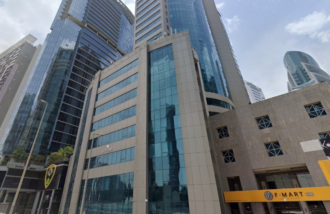 Street-level view of Ontario Tower; expert real estate services for buying or leasing in this iconic building.