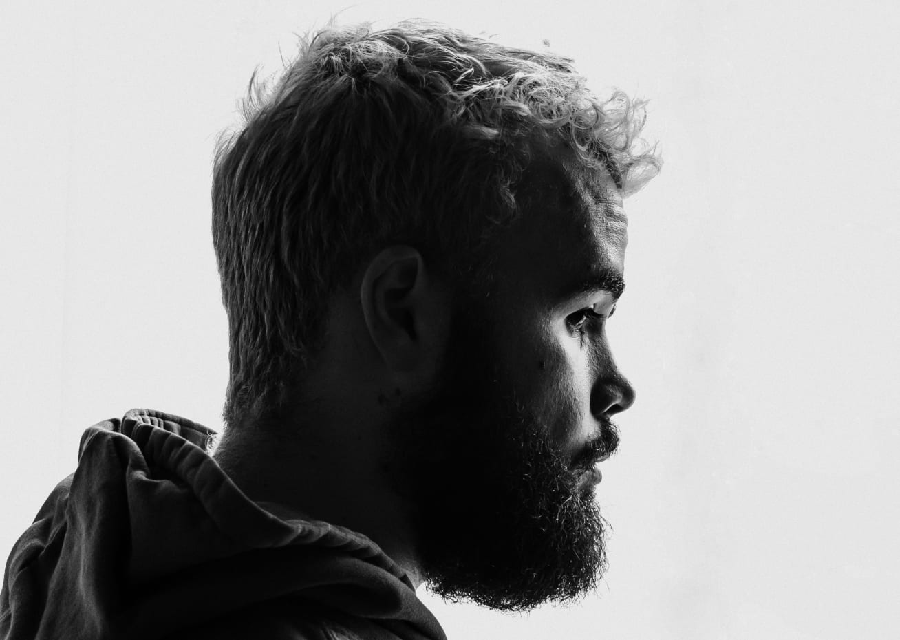 Black and white photo of man posing on camera