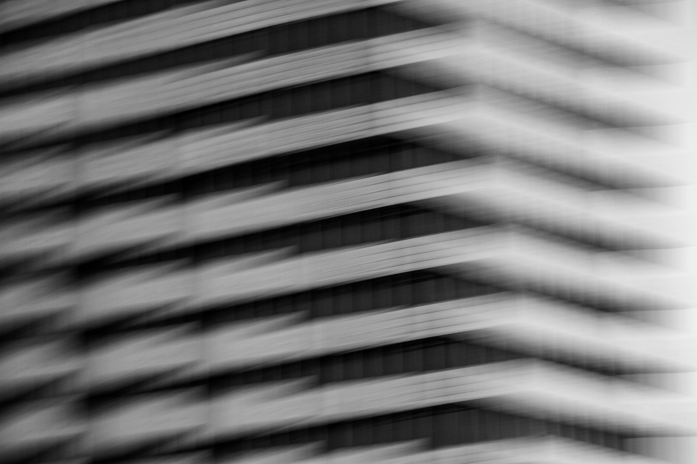 Abstract motion-blurred modern building facade representing marketing pipeline acceleration and RevOps growth metrics.