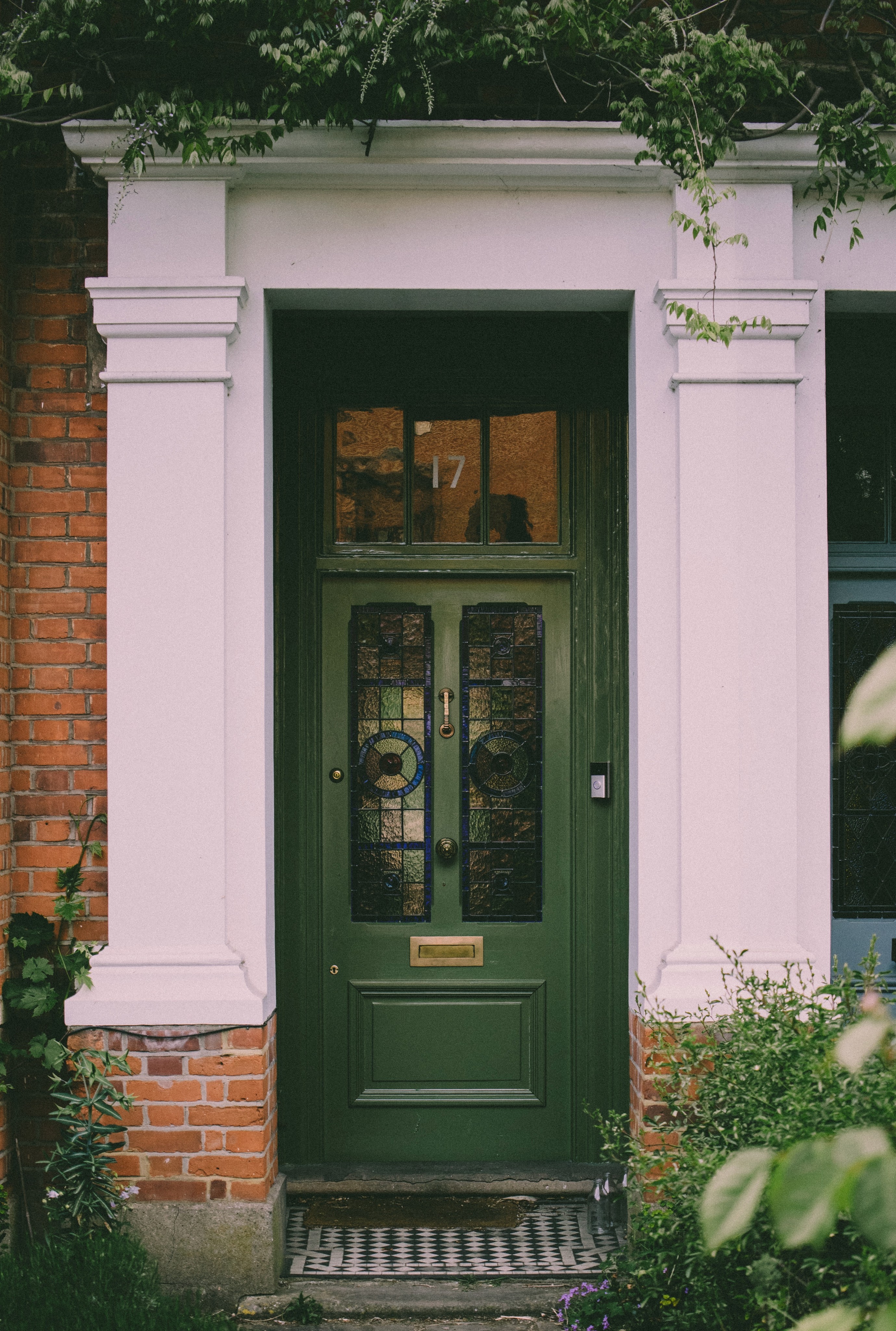 Green wooden door with glass.