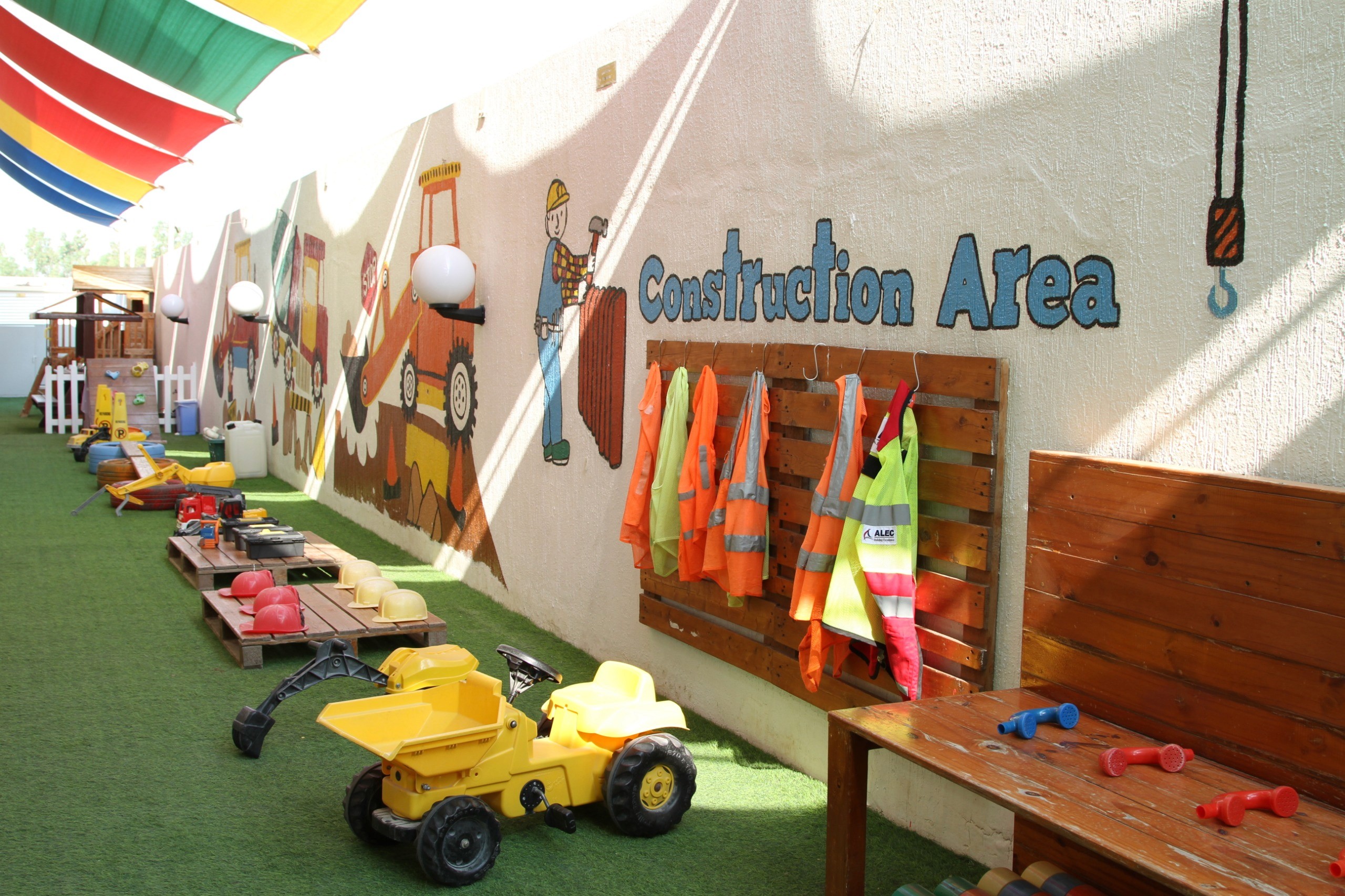 Outdoor play area with ride-on toys at Kinder Castle Nursery