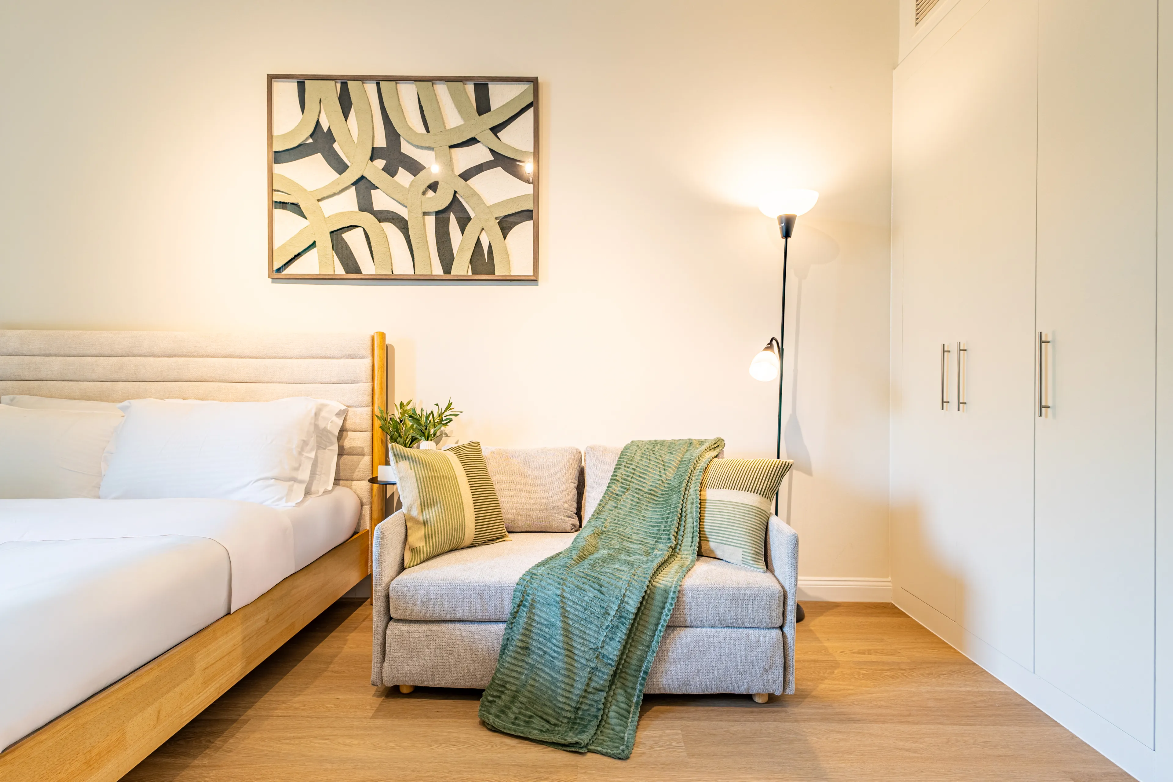 Picture of a small couch in bedroom.