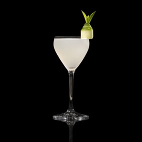 A closeup of a Cucumber Martini drink against a dark background.